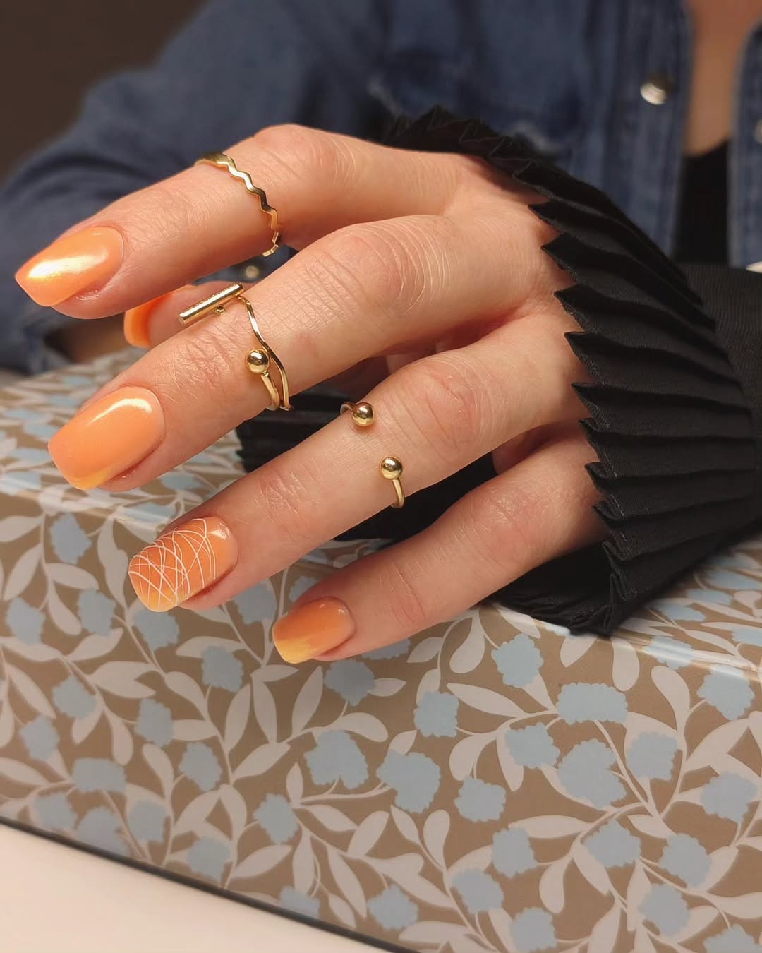 Vibrant Orange Ombre with White Swirl Accent Nails