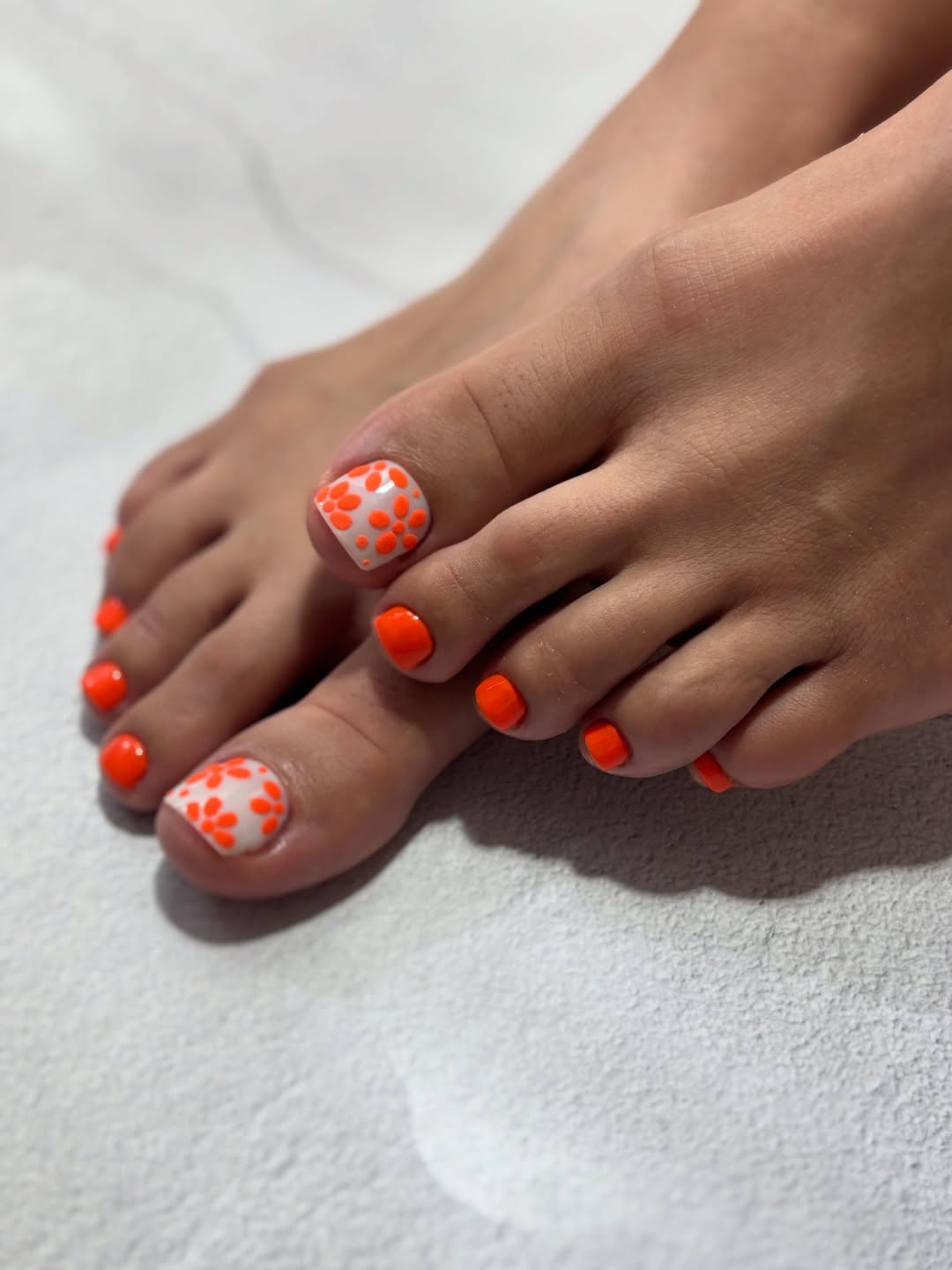 Vibrant Orange Pedicure with Playful Dotted Big Toe