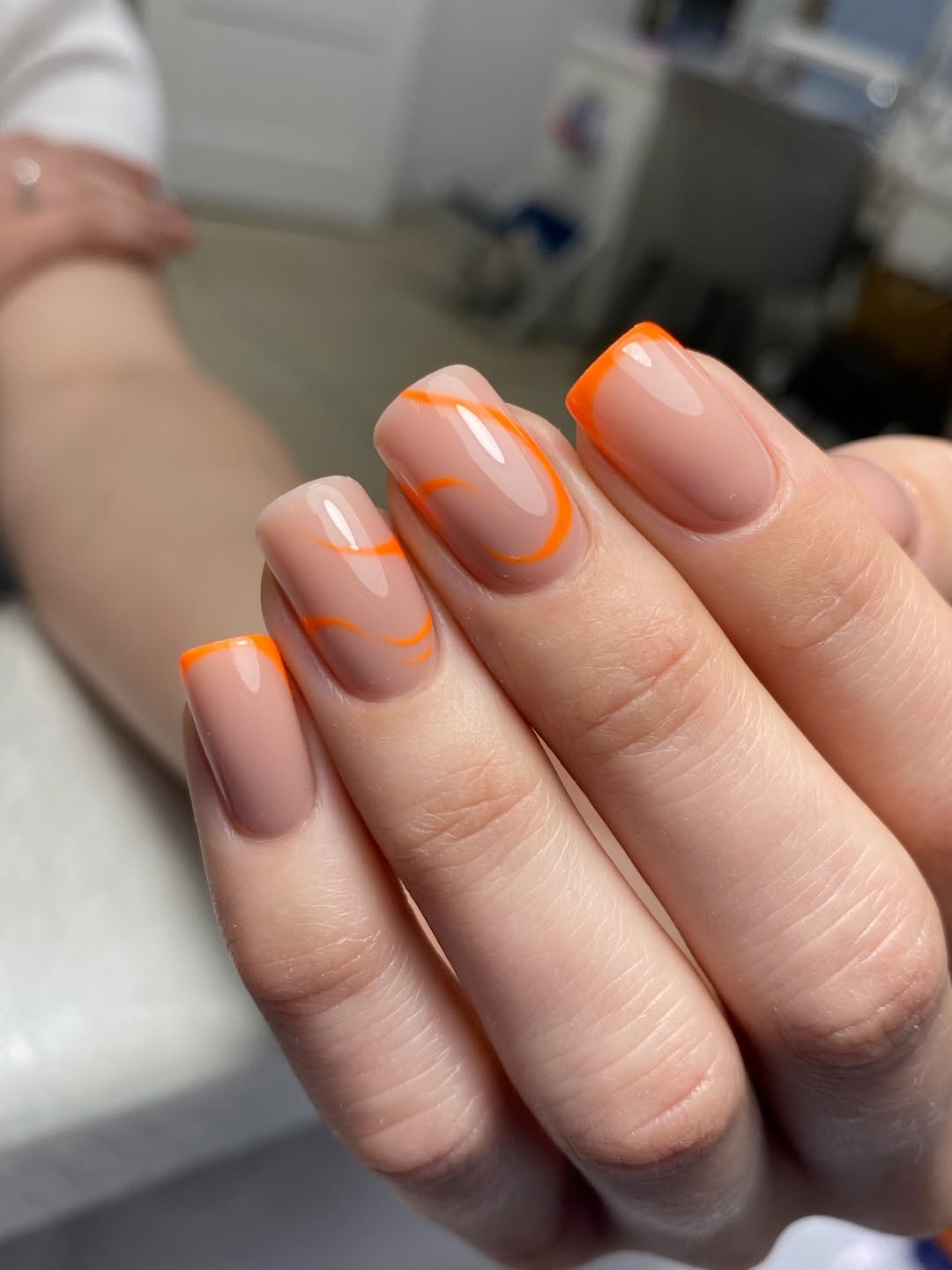 Vibrant Orange Swirl and French Tip Nails