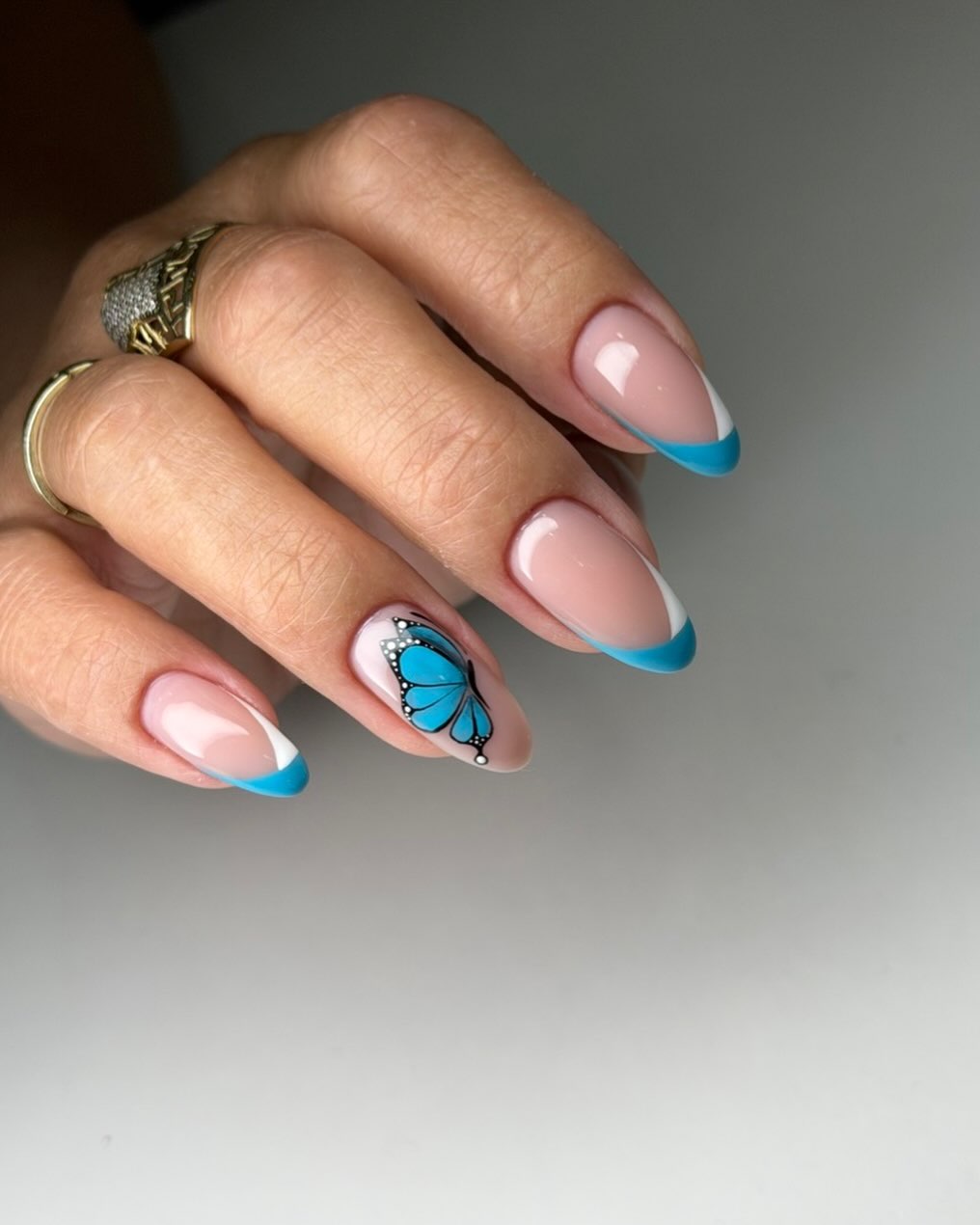 Vibrant Teal French Tips with Butterfly Accent