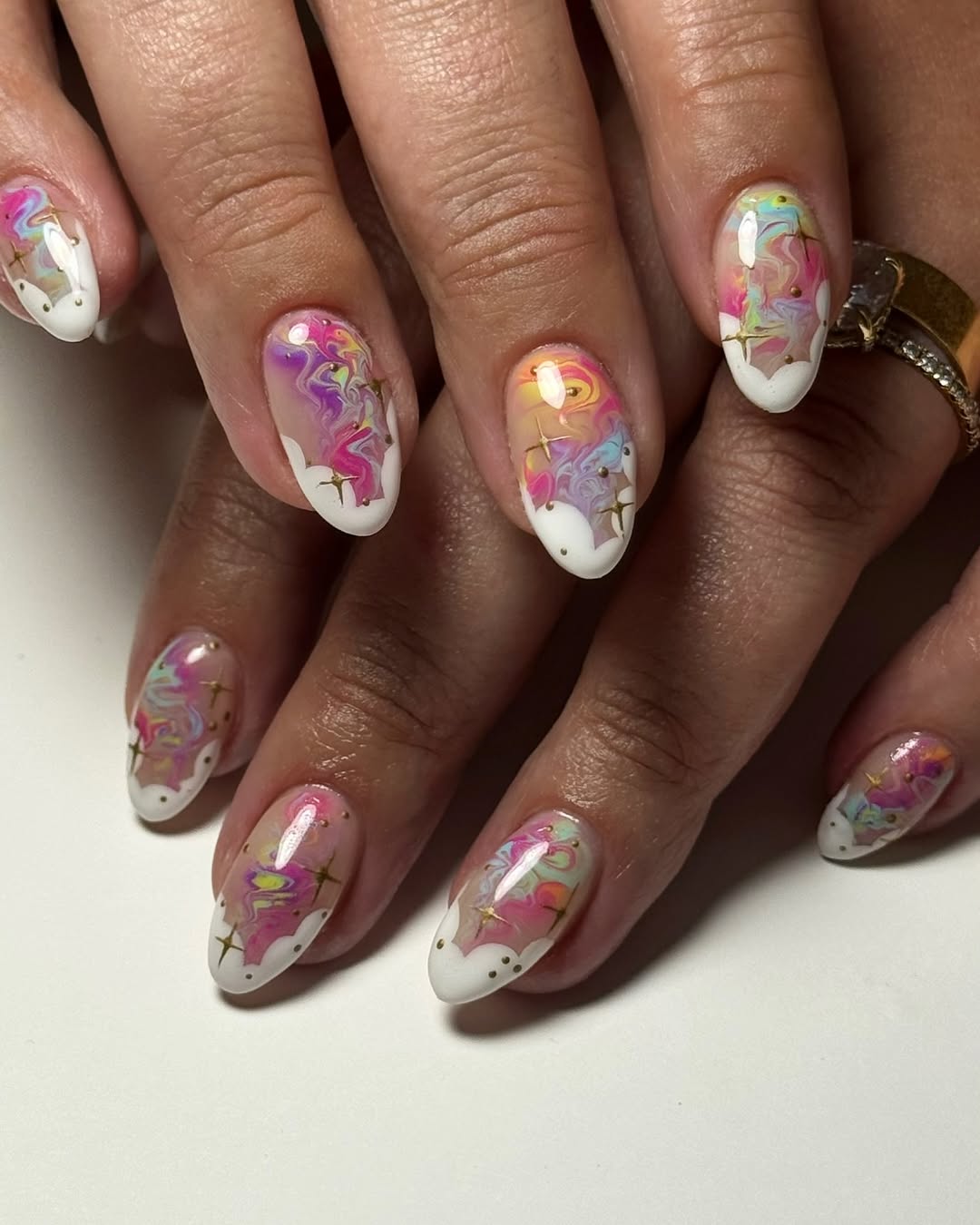 Whimsical Marble Cloud Almond Nails with Gold Stars
