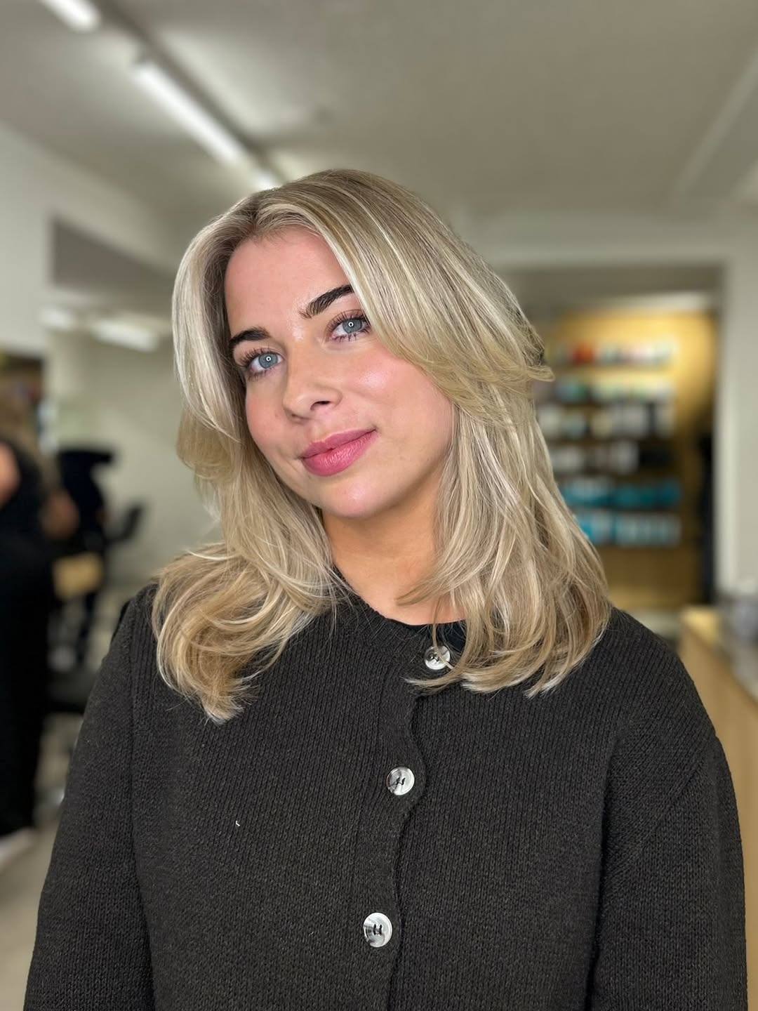 Blonde Layers With Face-Framing Curtain Bangs