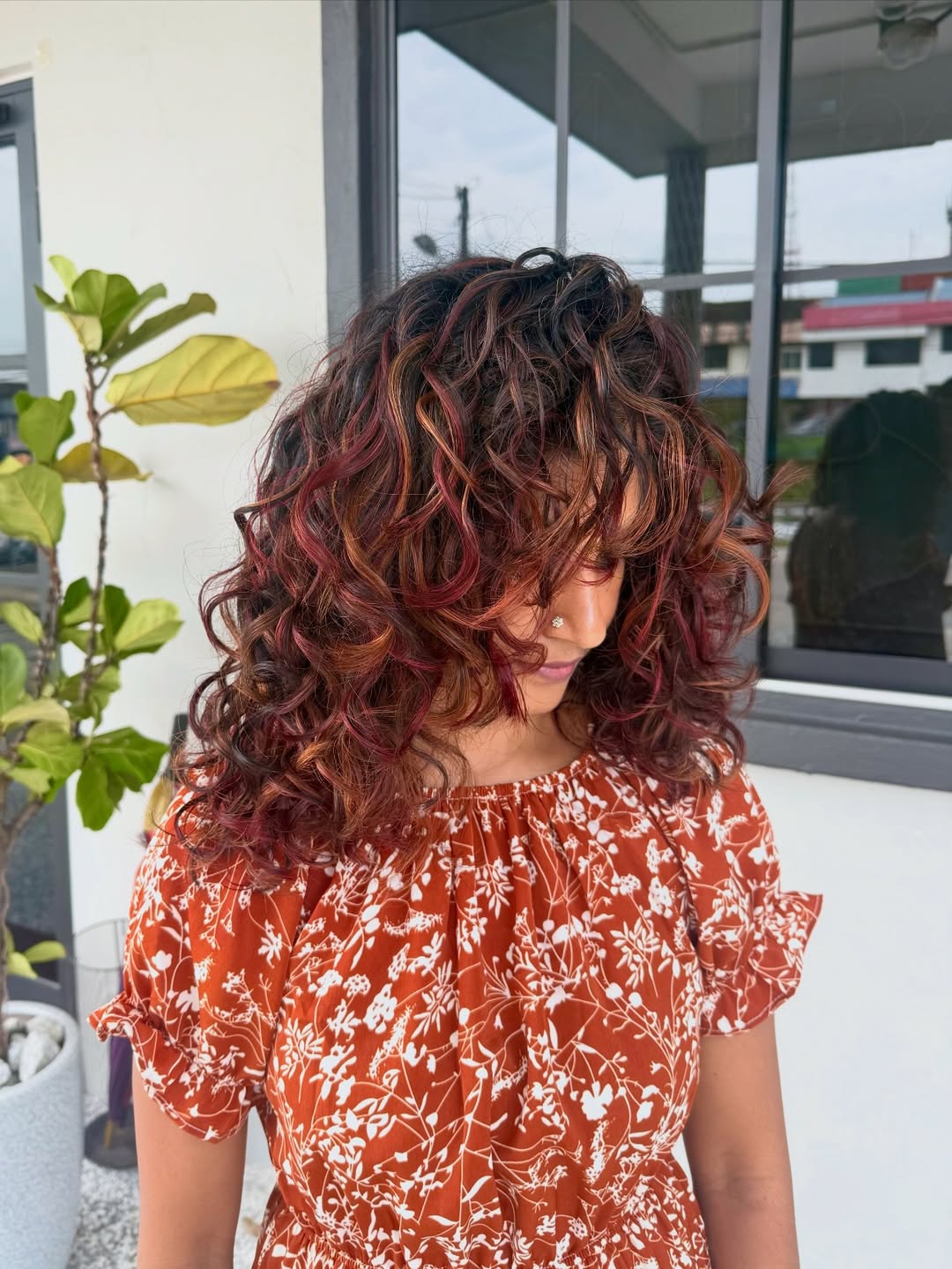 Bold Cherry Red Highlights On Voluminous Curls