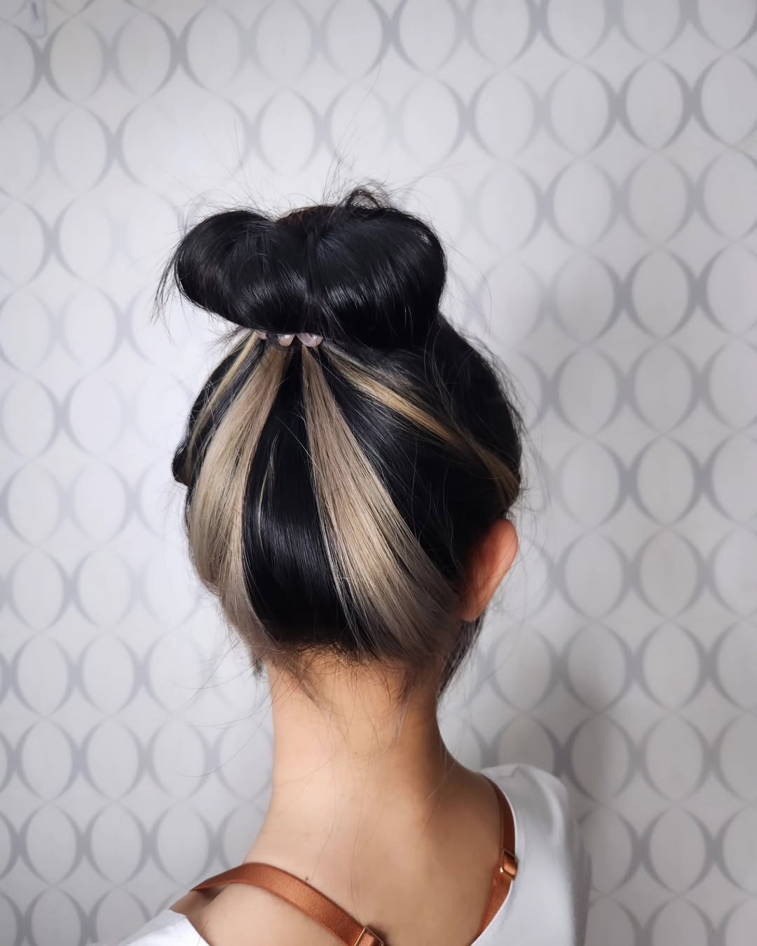 Bold Peekaboo Streaks In Messy High Bun