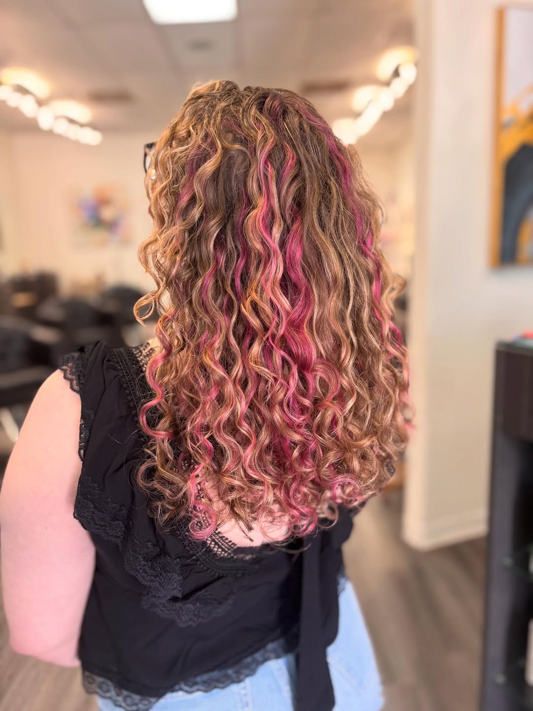 Bold Pink Peekaboo Highlights on Blonde Curls