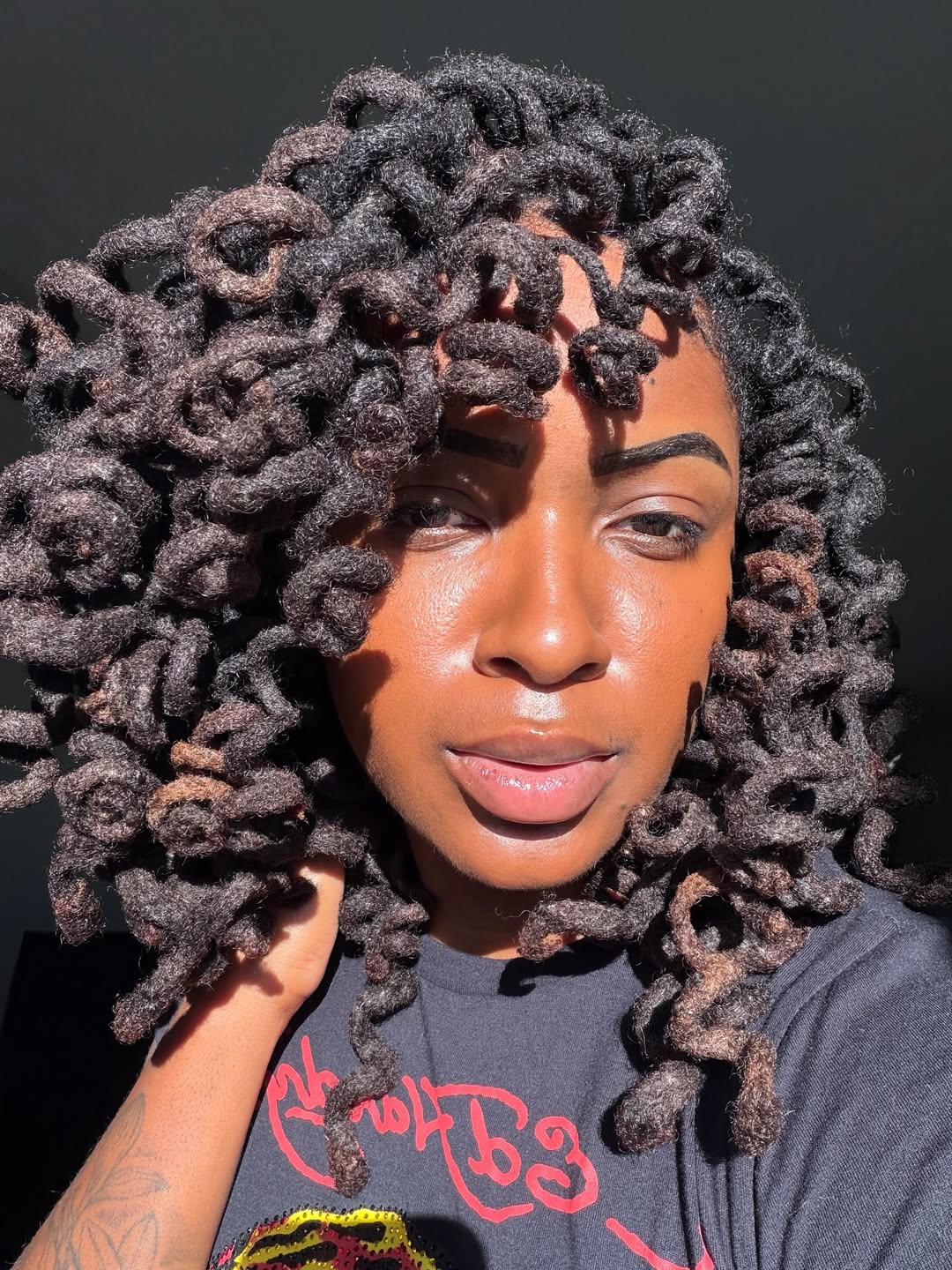 Bouncy Coiled Locs With Hints Of Auburn