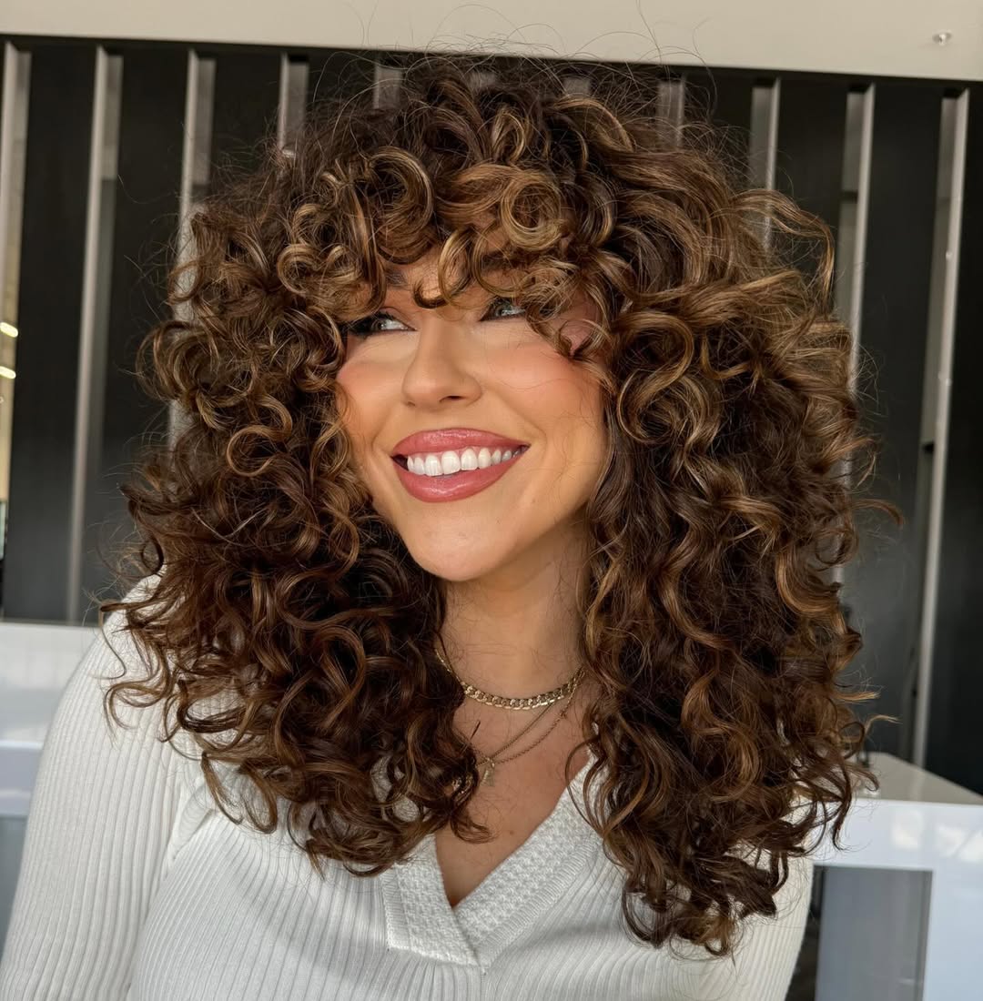 Bouncy Curly Shag Cut With Honey Highlights
