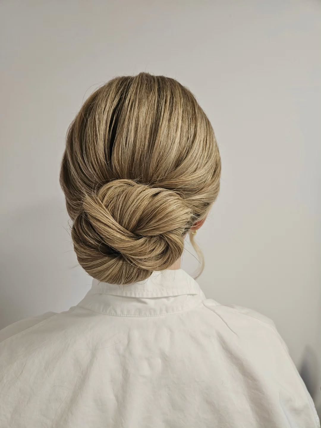Braided Low Bun With Honey Blonde Highlights