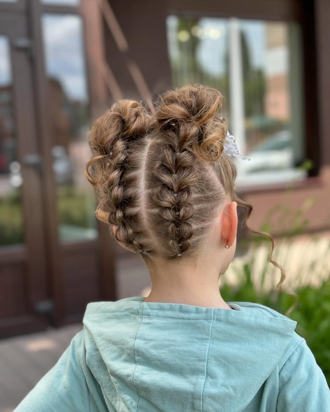 Braided Pigtail Buns With Loose Tendrils