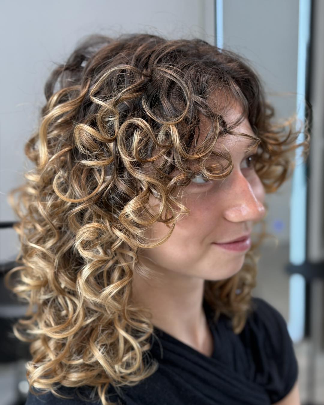 Caramel Highlights On Curly Shoulder-Length Hair