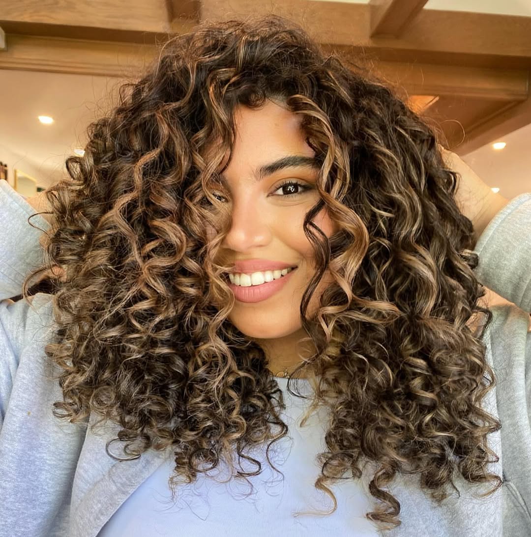 Caramel Highlights On Voluminous Curly Hair
