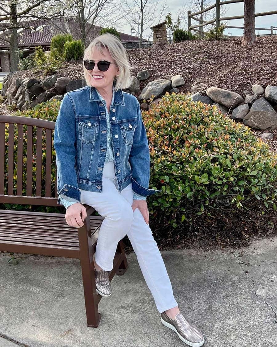 Classic Denim Jacket With White Jeans And Metallic Slip-Ons
