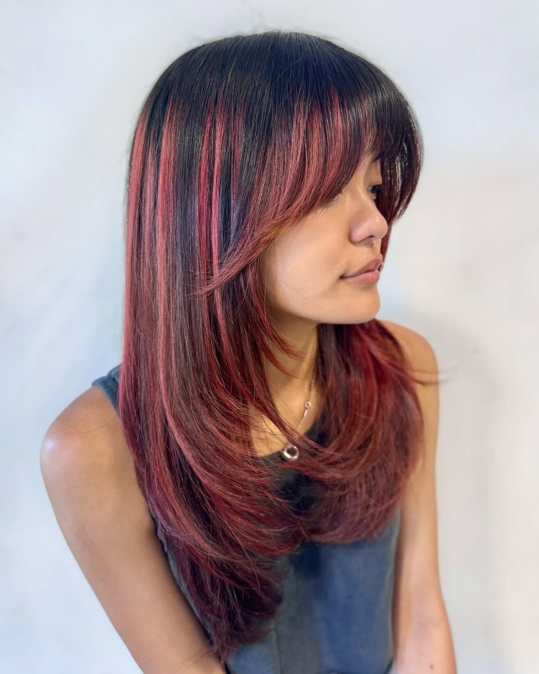 Crimson Hues Medium Layers With Curtain Bangs