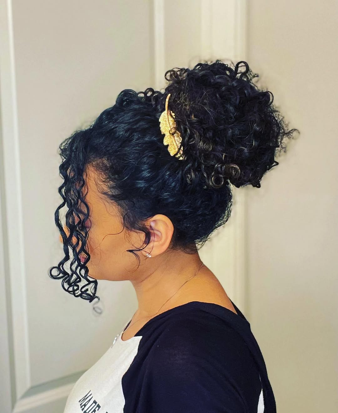 Defined Curly High Bun With Gold Accent