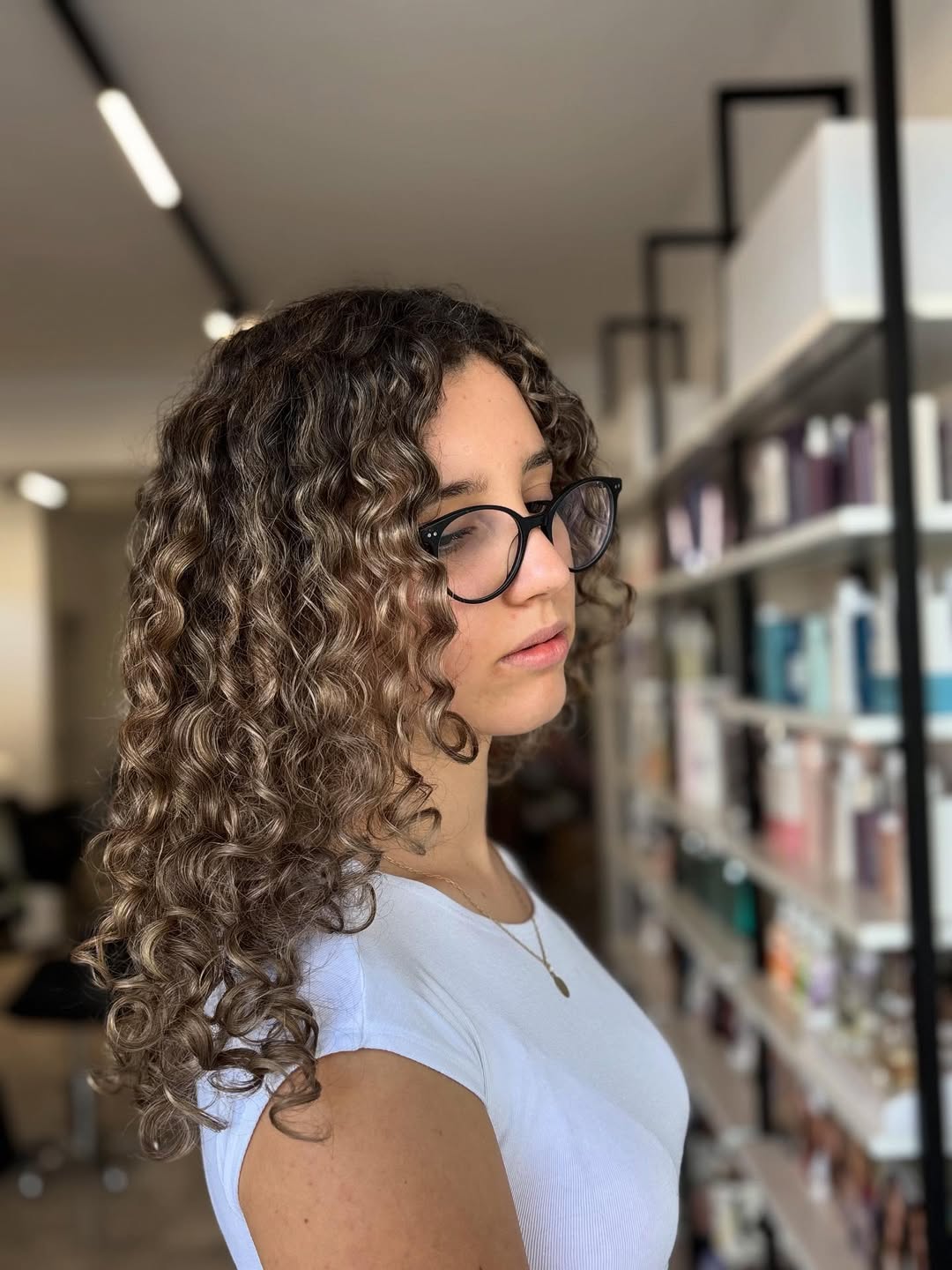 Defined Curly Shoulder-Length Brown Hair With Caramel Highlights