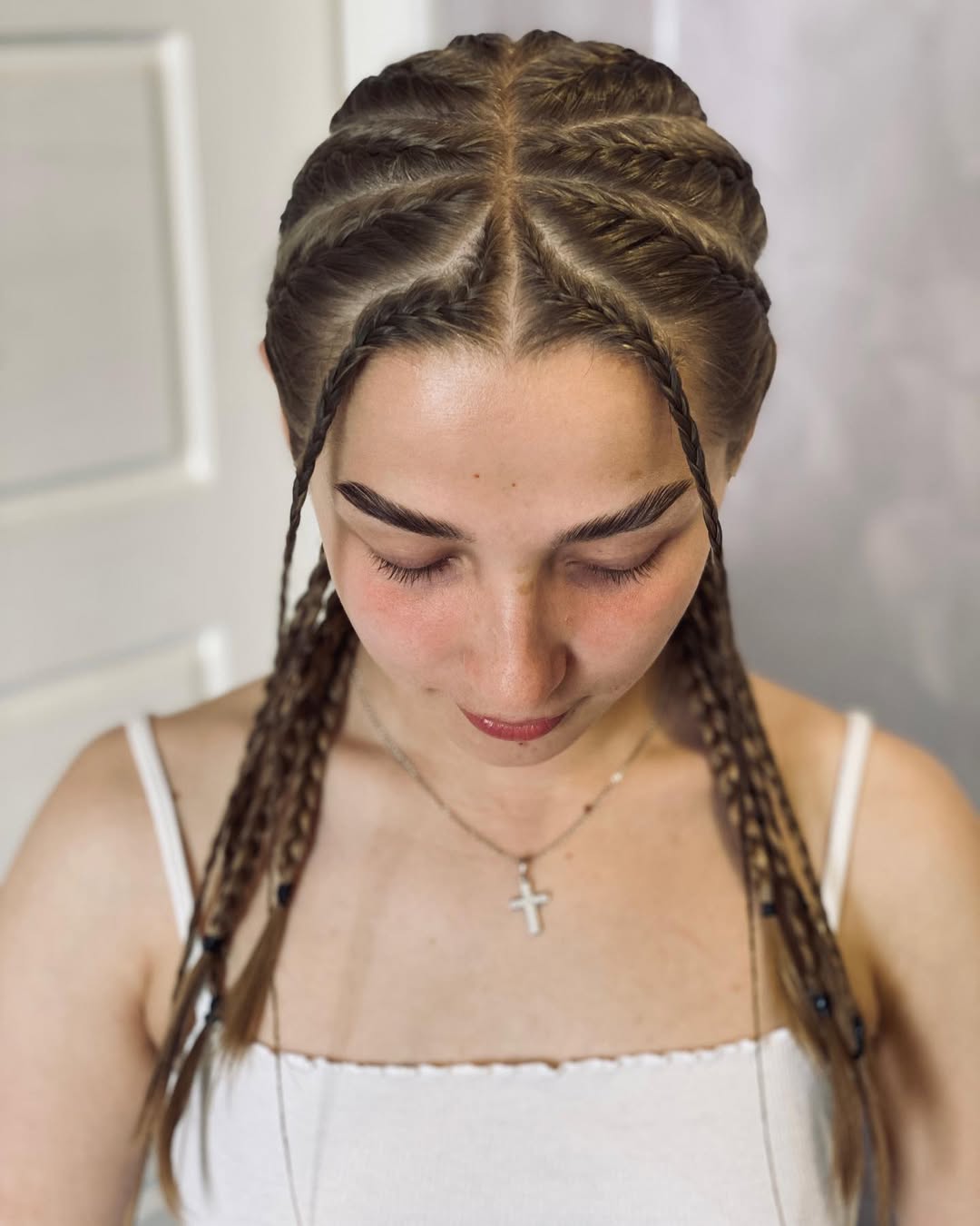 Detailed Crown Braids With Dangling Strands