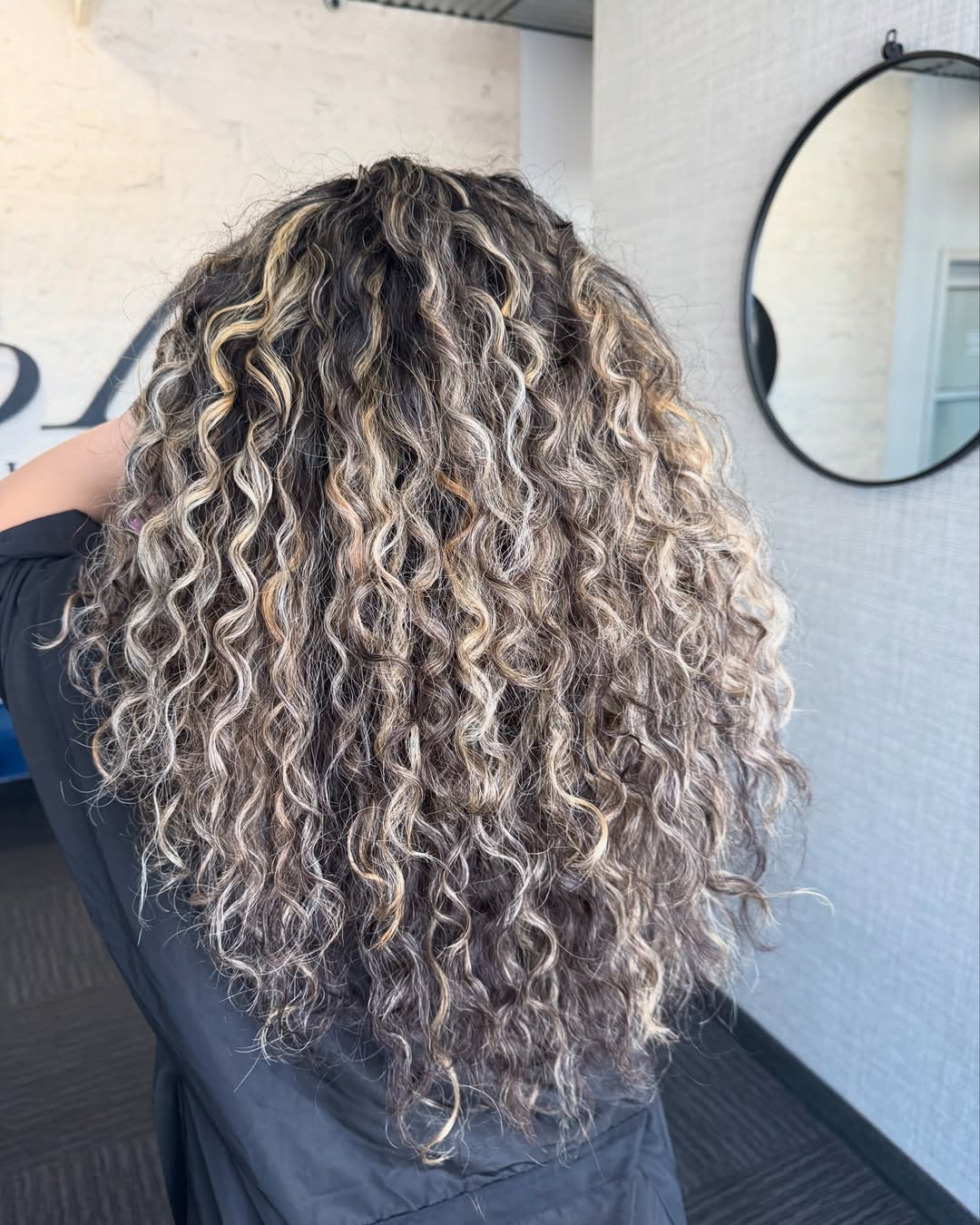 Dimensional Blonde Highlights On Long Curly Hair