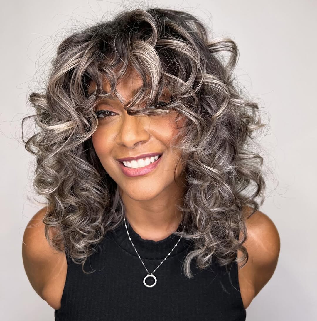 Dimensional Gray Balayage Shoulder-Length Curls with Bangs