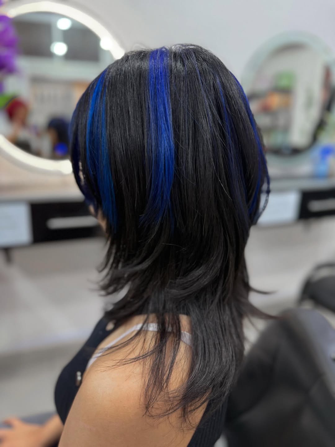 Edgy Black Wolf Cut With Electric Blue Streaks