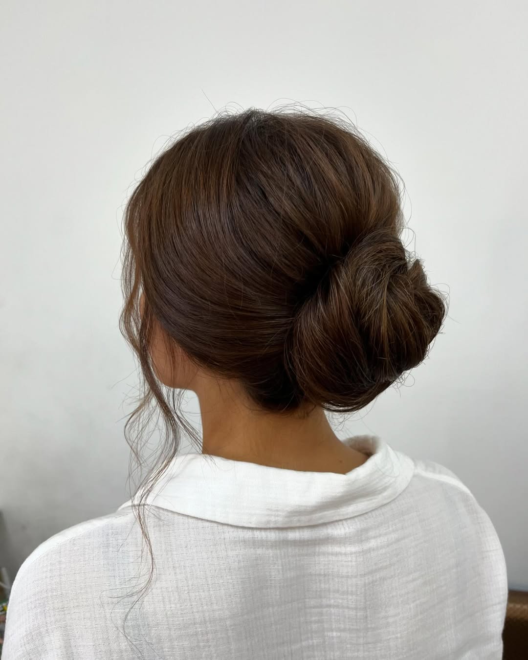 Effortless Low Bun With Face-Framing Tendrils