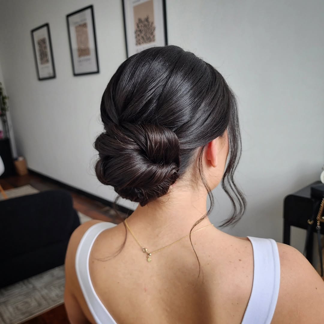 Elegant Braided Low Bun With Face-Framing Tendrils