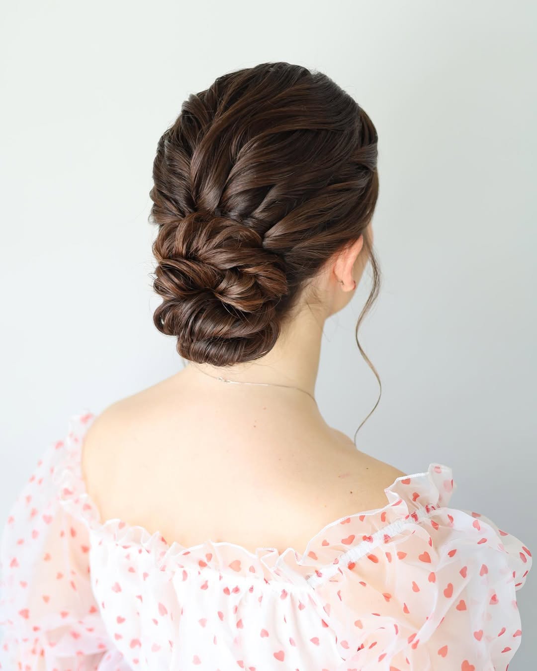 Elegant Braided Updo With Loose Tendrils
