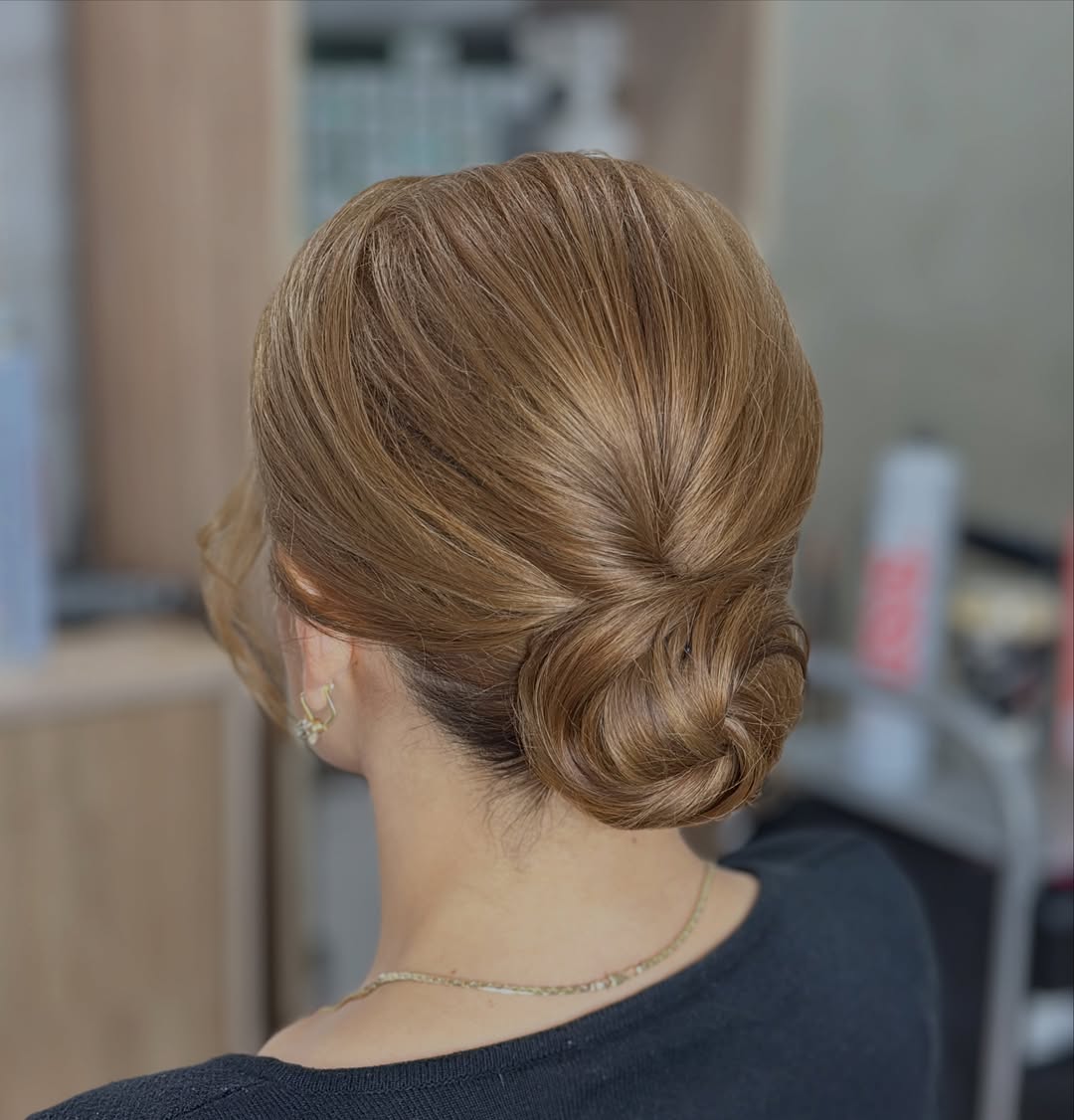 Elegant Low Twisted Chignon With Honey Blonde Highlights