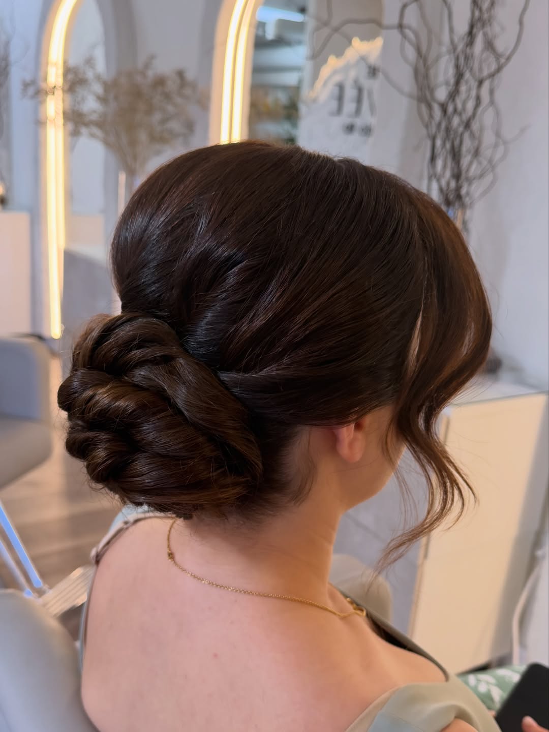Elegant Twisted Chignon With Wispy Face Framing Strands