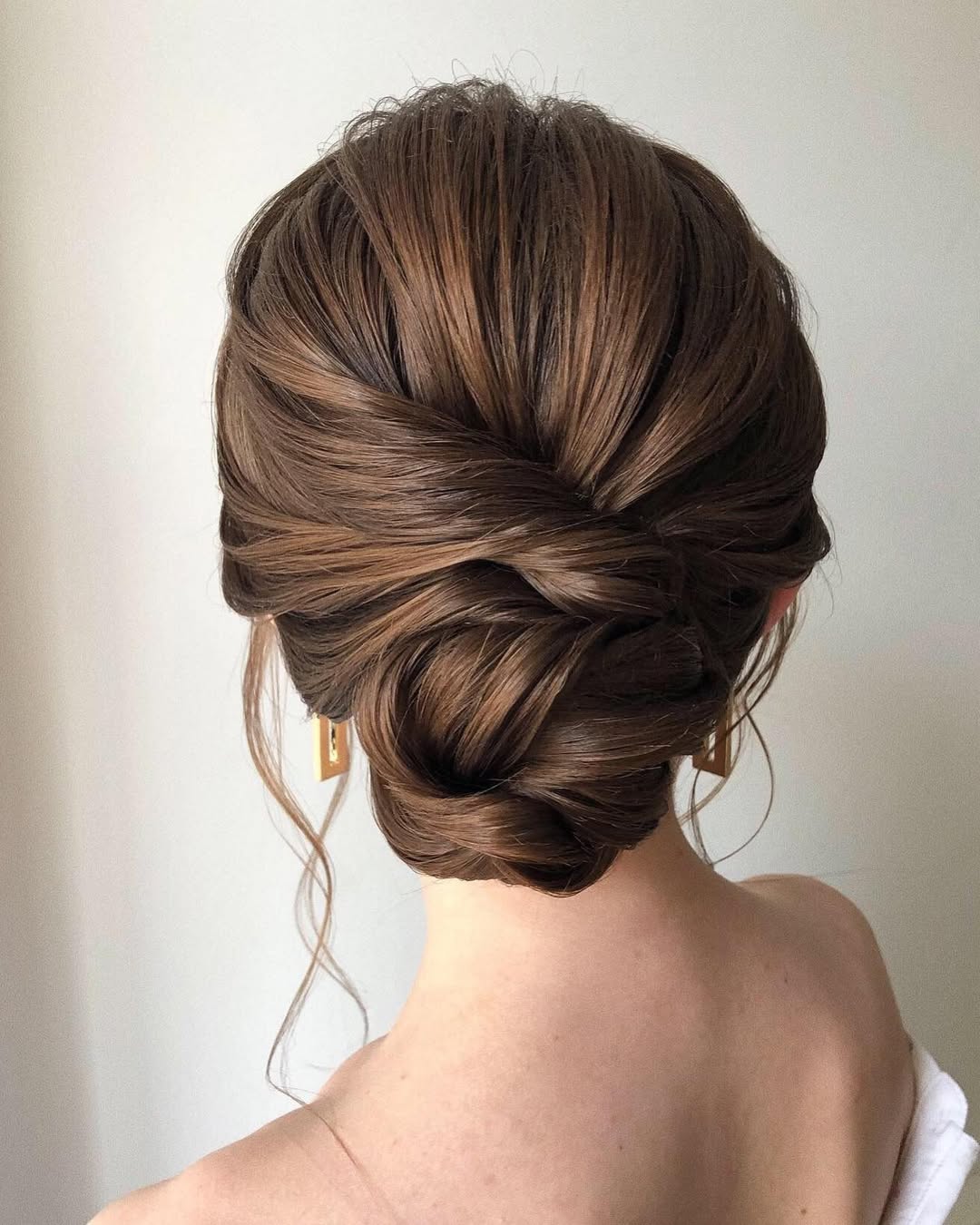 Elegant Twisted Low Bun With Face-Framing Tendrils