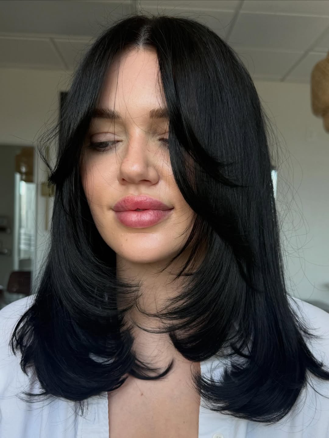 Feathered Black Layers With Face-Framing Bangs