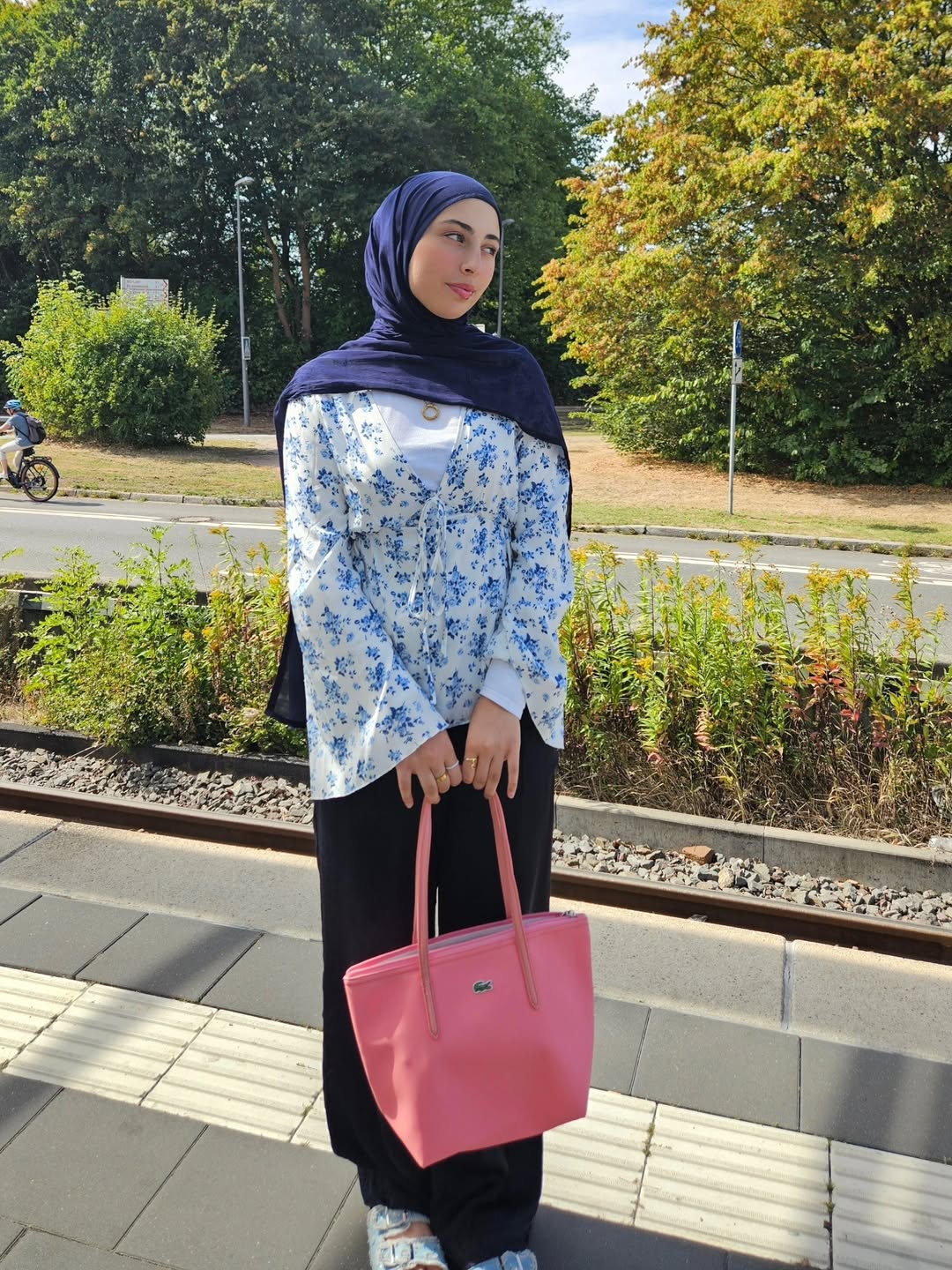 Floral Blouse With Black Trousers And Bright Tote