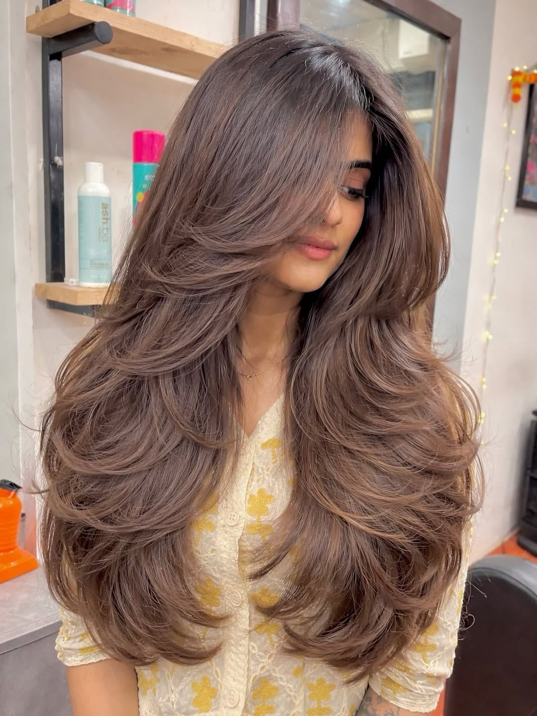 Glamorous Wavy Layers With Voluminous Face Framing Bangs