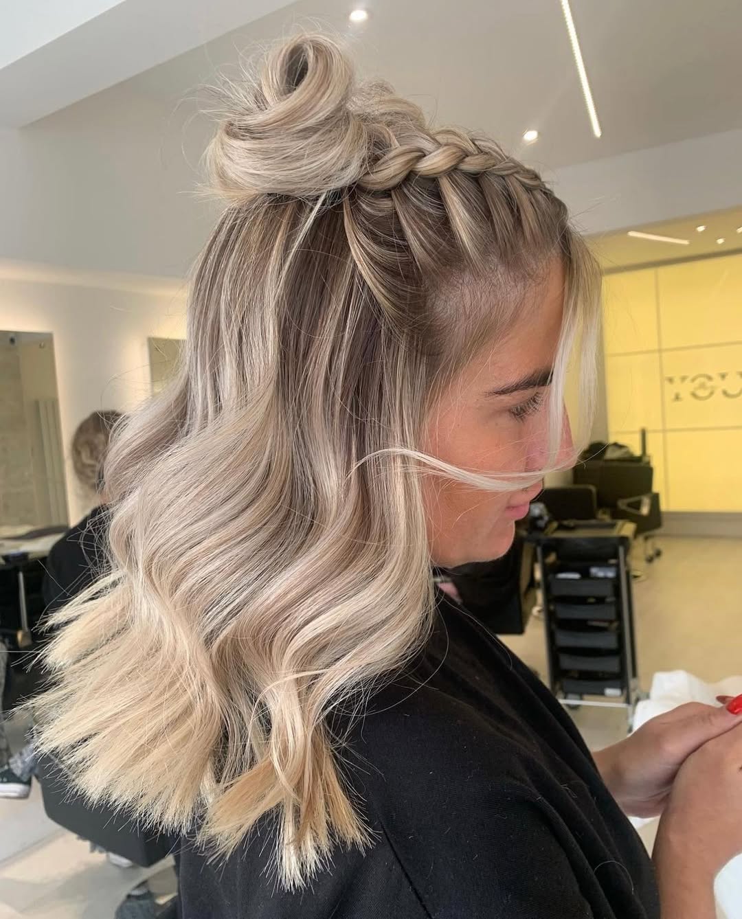 Half-Up Braided Bun On Wavy Ash Blonde Lob