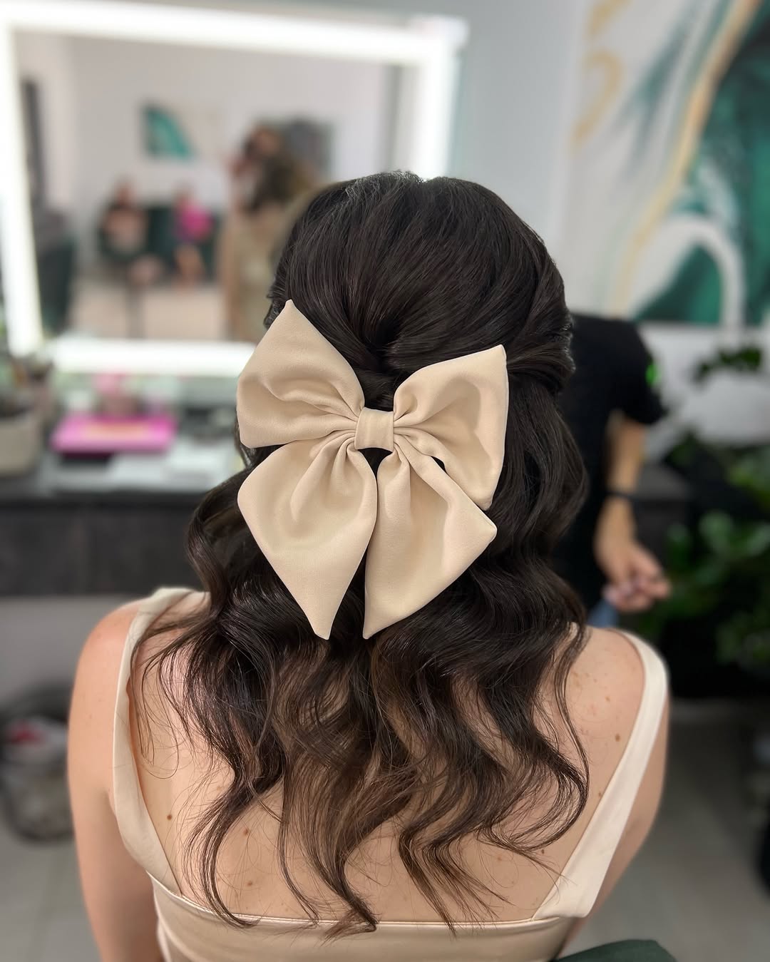 Half Updo With Loose Waves And Statement Bow