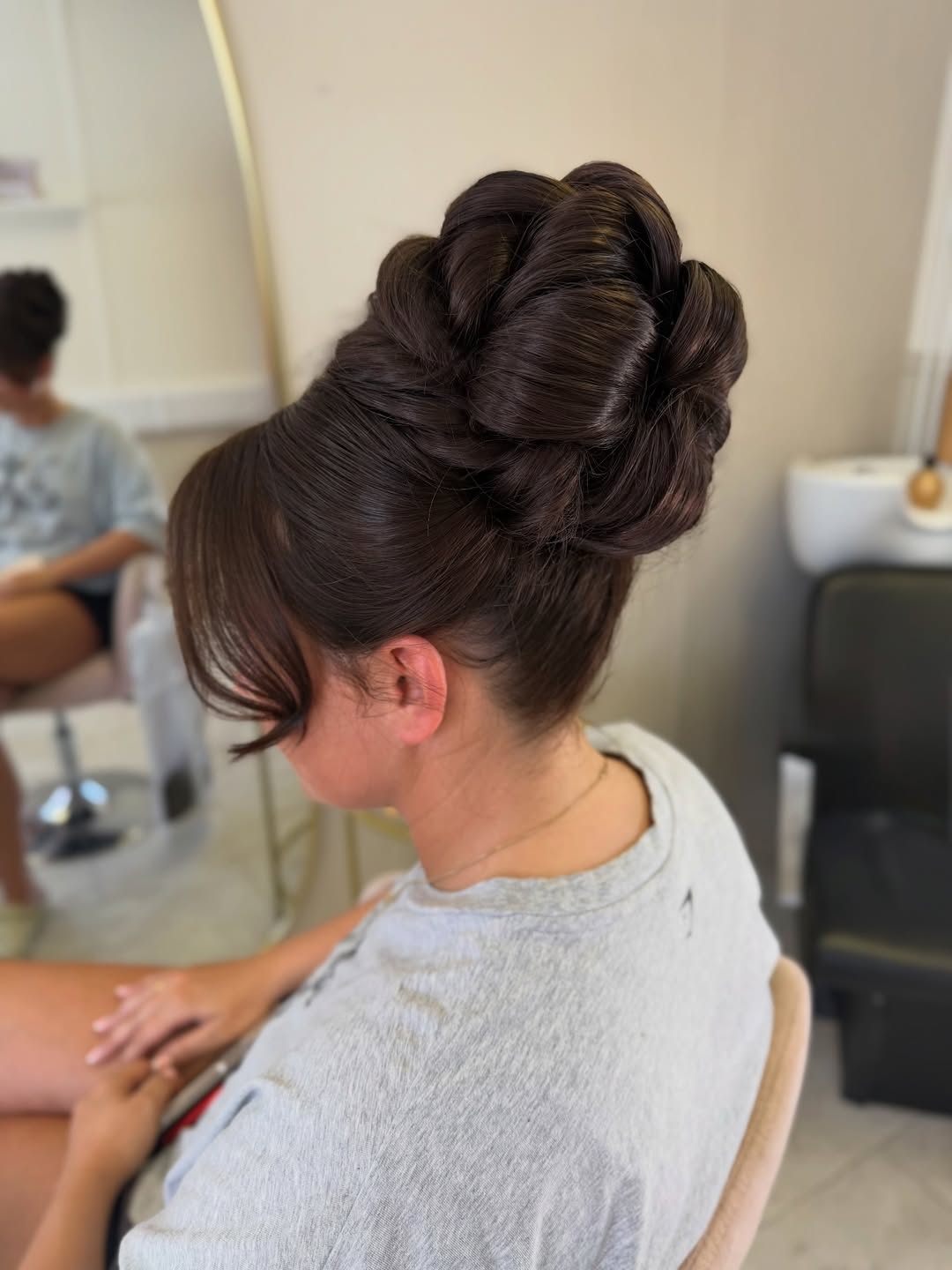 Intricate Braided High Bun With Wispy Fringe