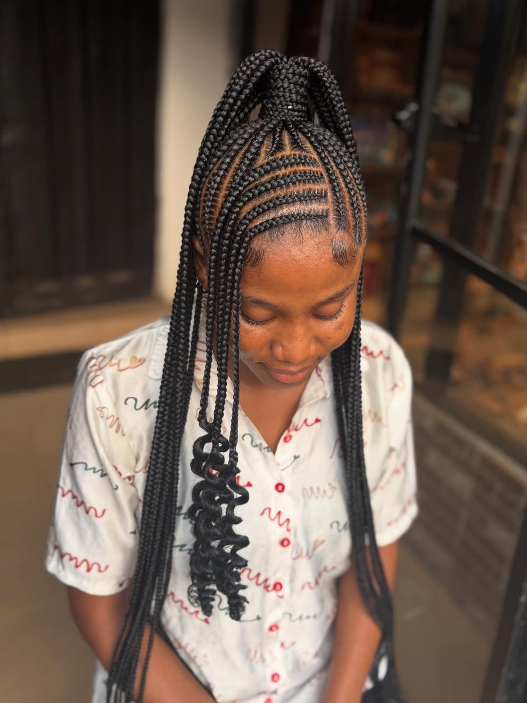 Intricate Cornrow Braids With Curly Pigtail Extensions