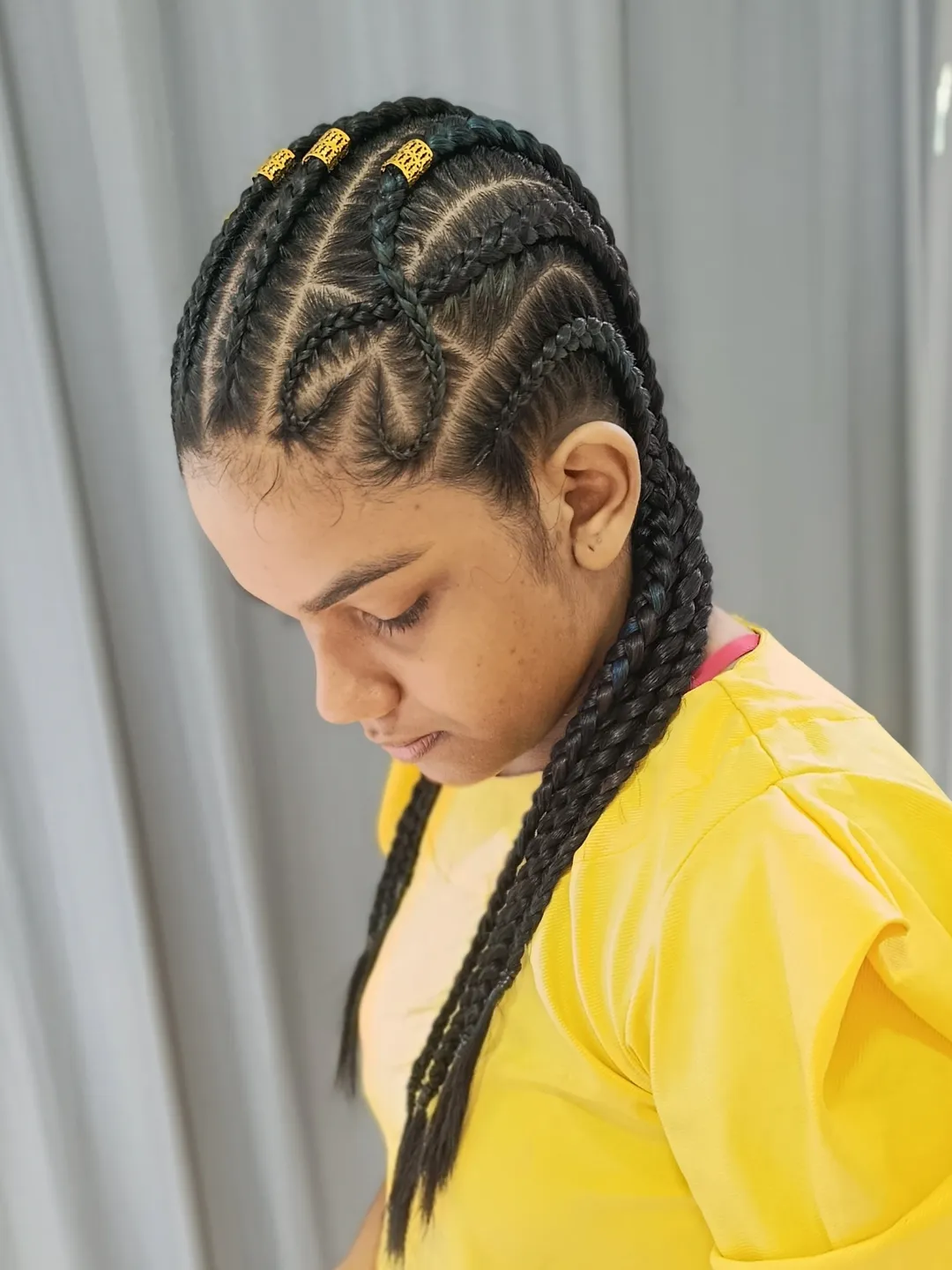 Intricate Cornrow Braids With Golden Adornments
