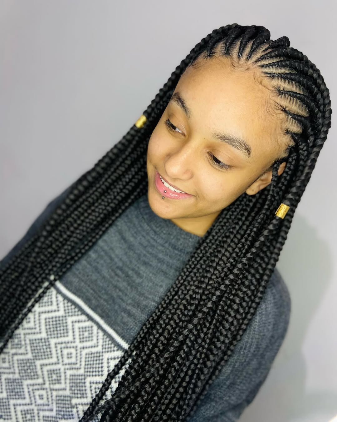 Long Fulani Braids With Gold Cuffs And Sleek Edges