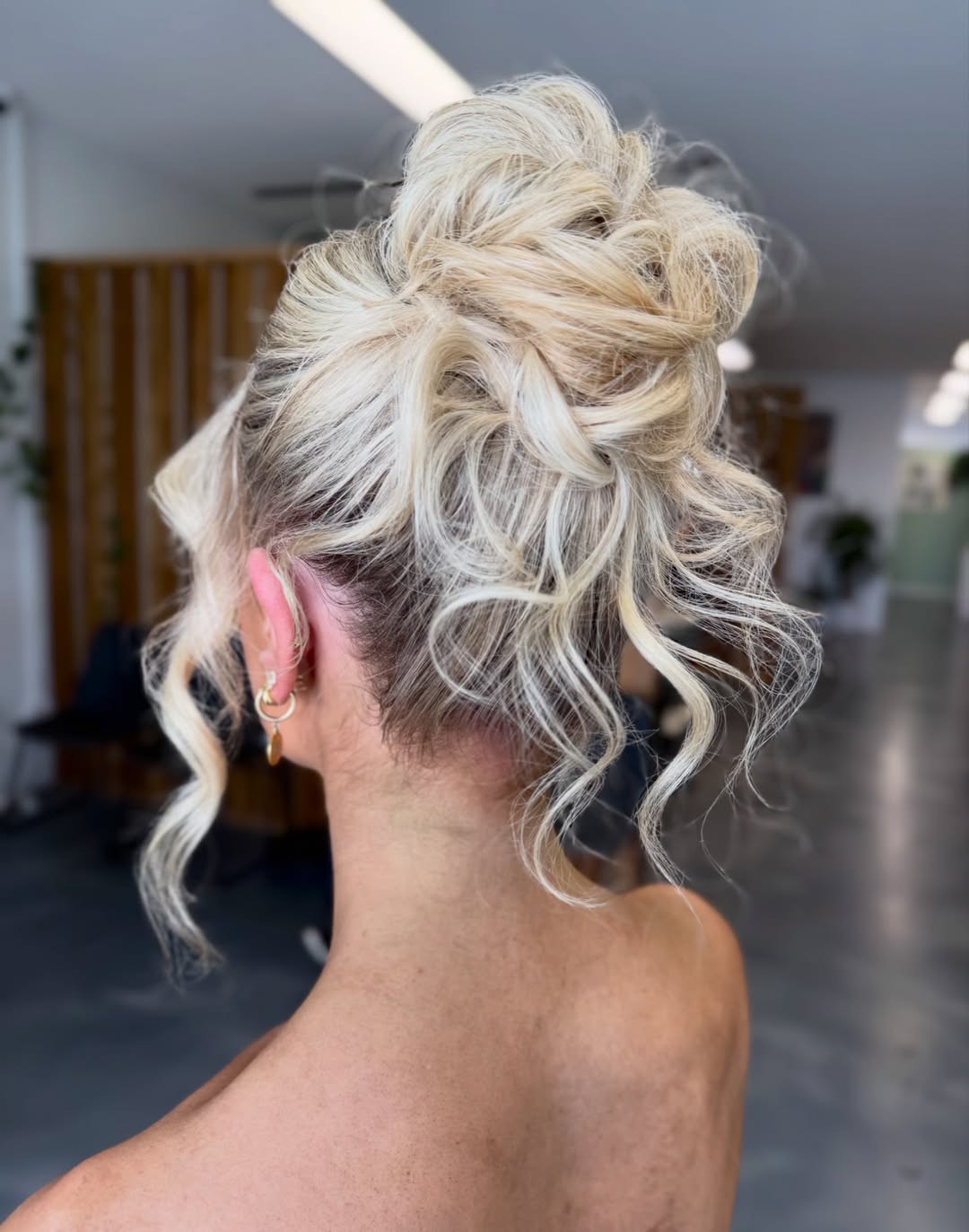 Messy Platinum Textured Updo With Wavy Tendrils