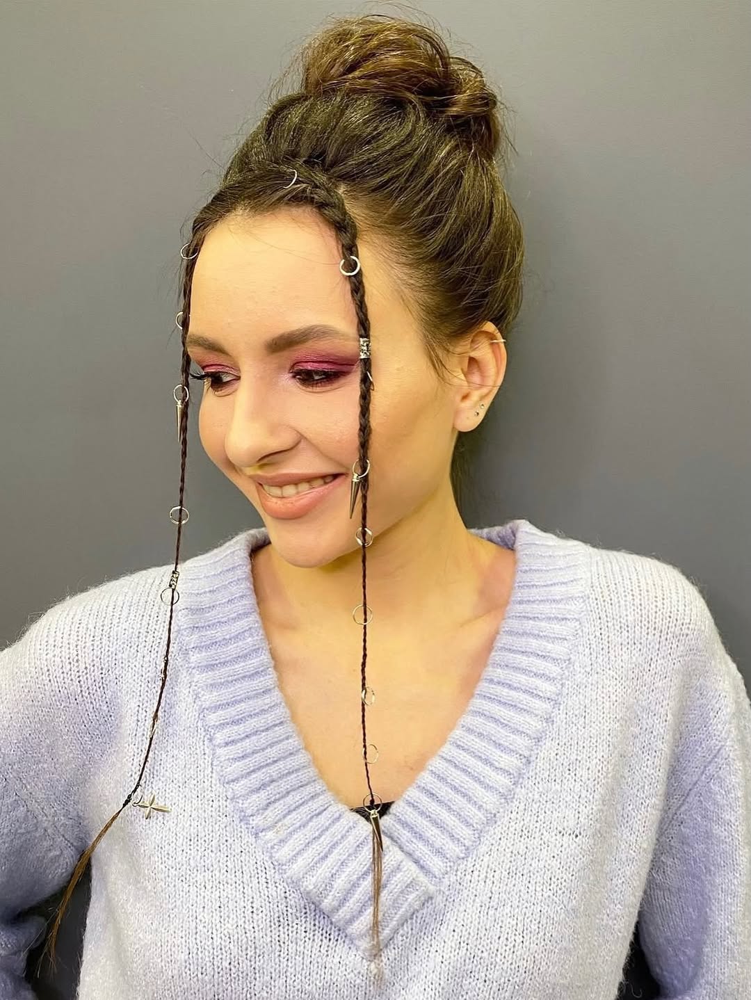 Messy Top Knot With Braided Face-Framing Tendrils