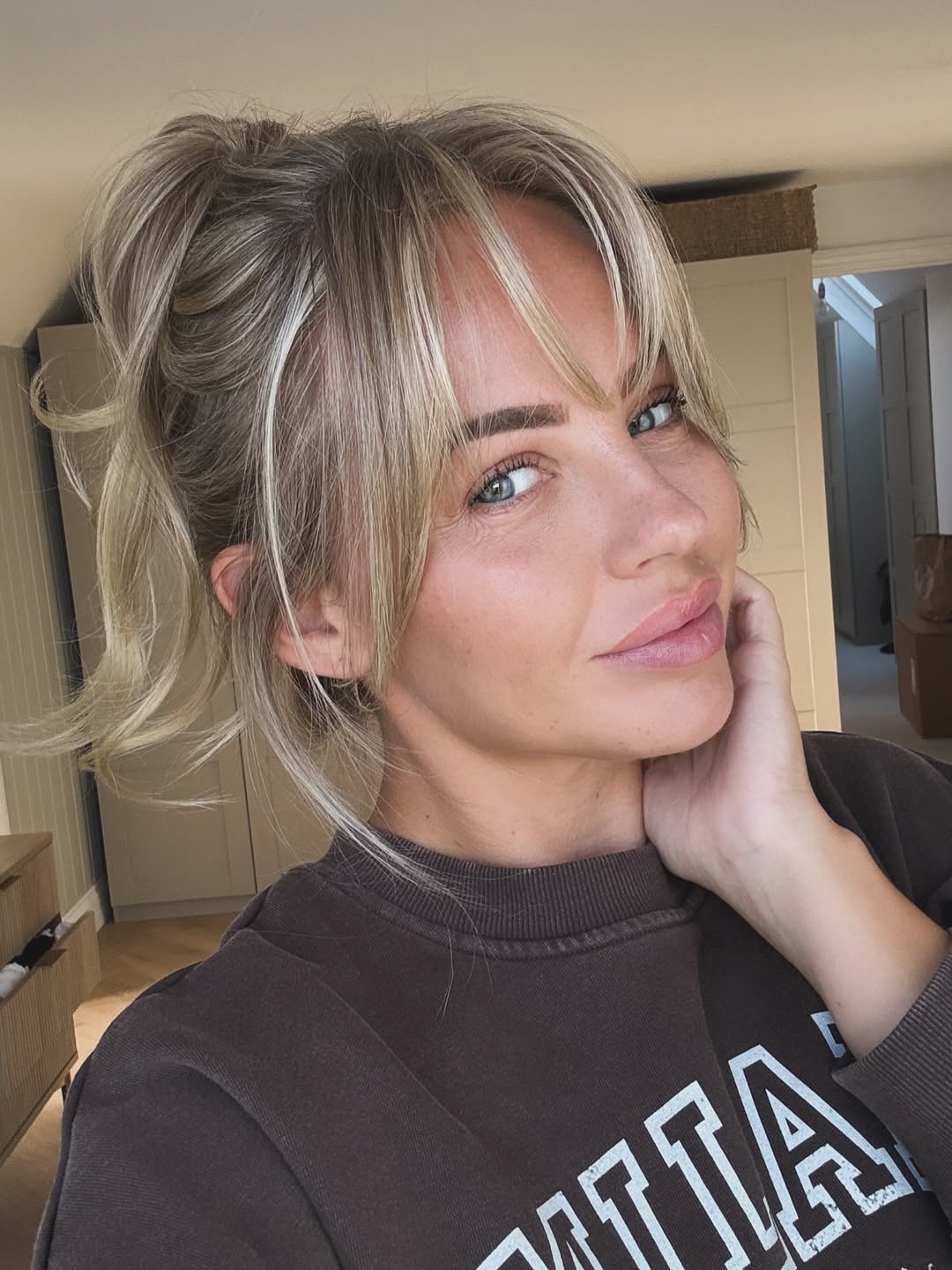 Messy Updo With Wispy Golden Blonde Bangs