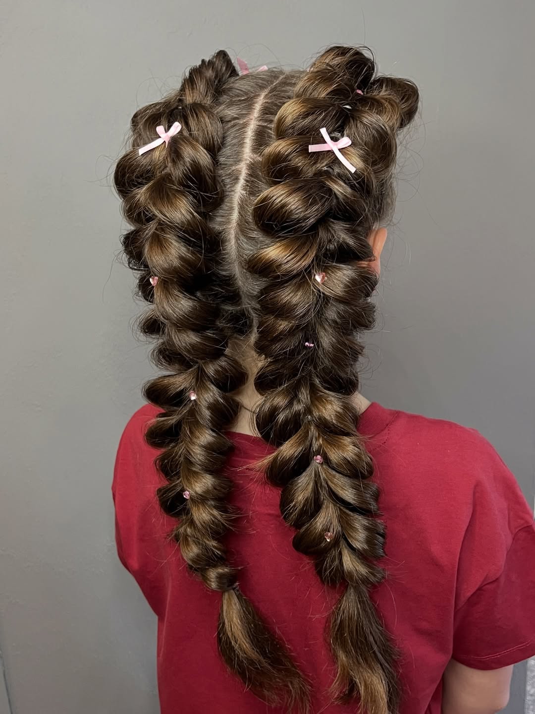 Playful Fishtail Braids With Pink Bow Accents