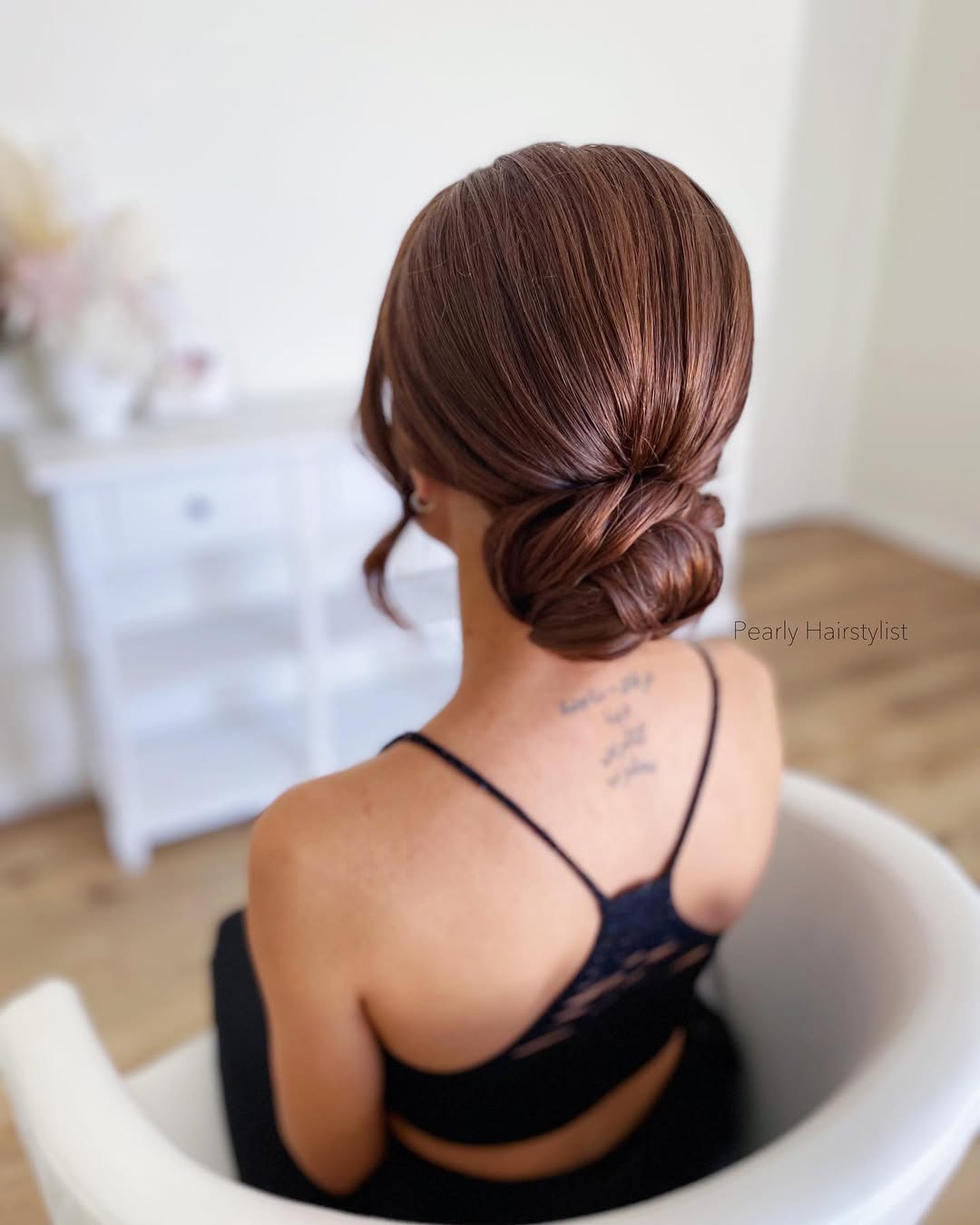 Polished Low Updo With Face-Framing Tendrils