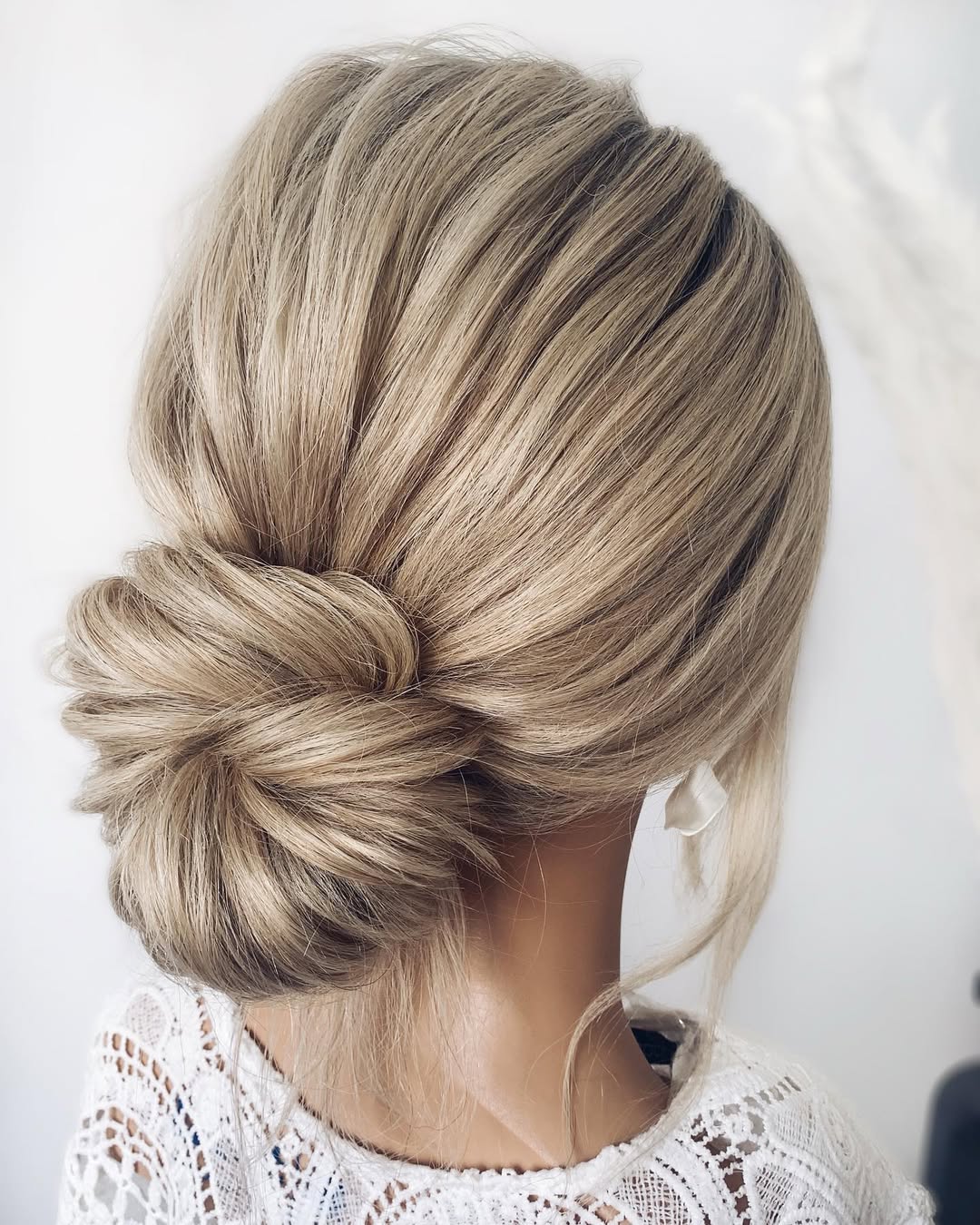 Relaxed Low Bun With Wispy Face-Framing Strands