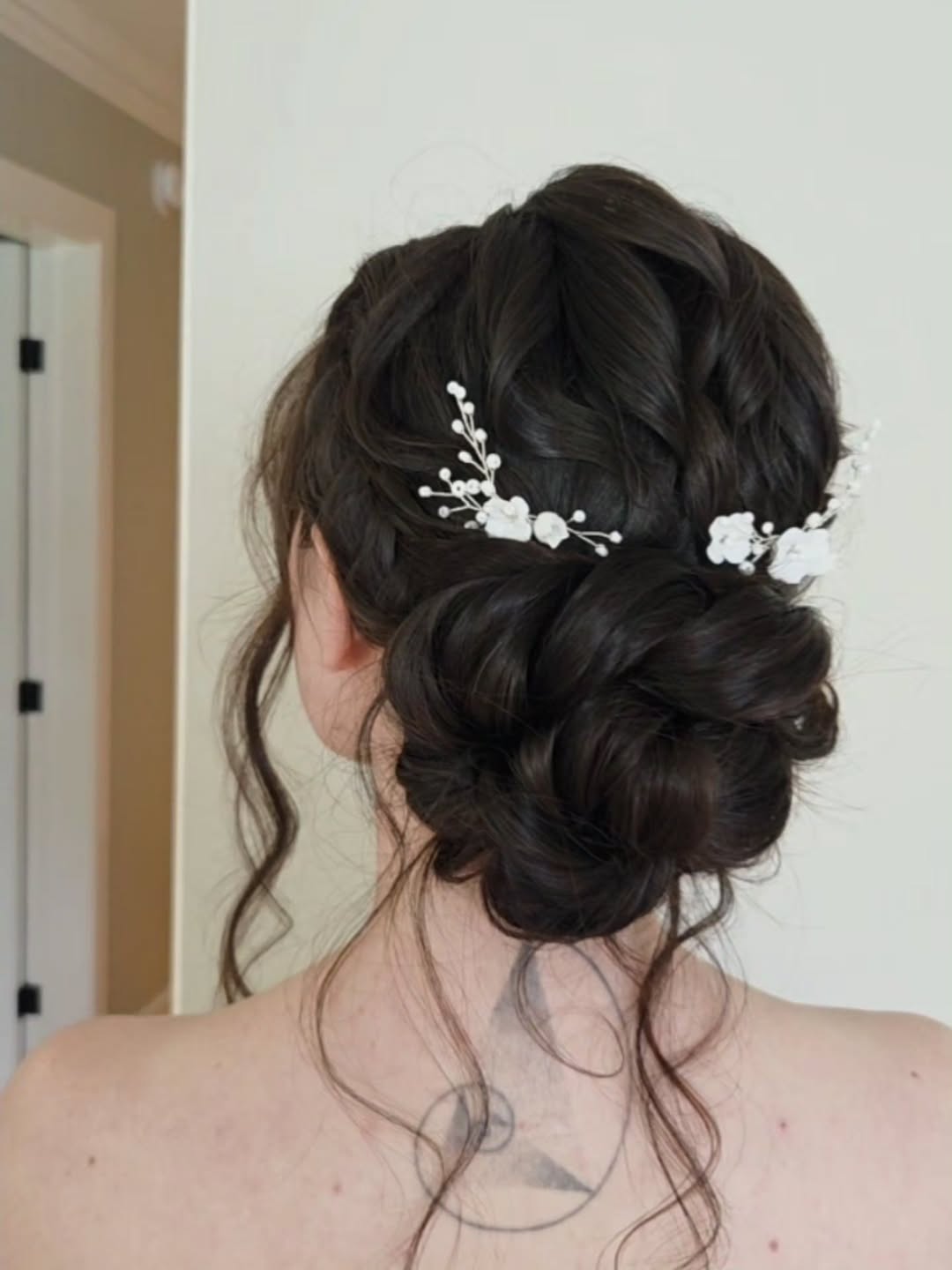 Romantic Low Bun With Delicate Floral Accents