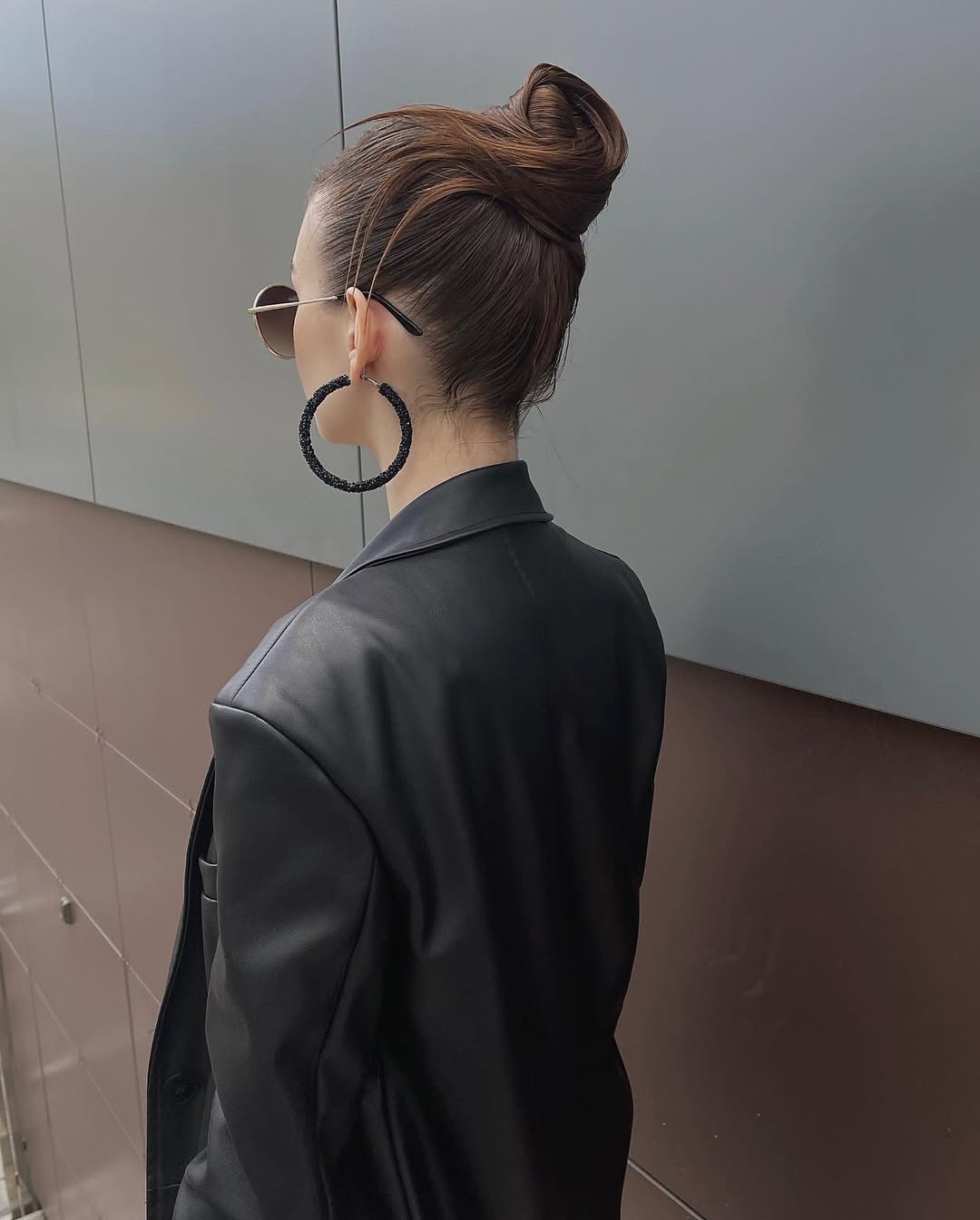 Sleek High Bun With Face Framing Tendrils