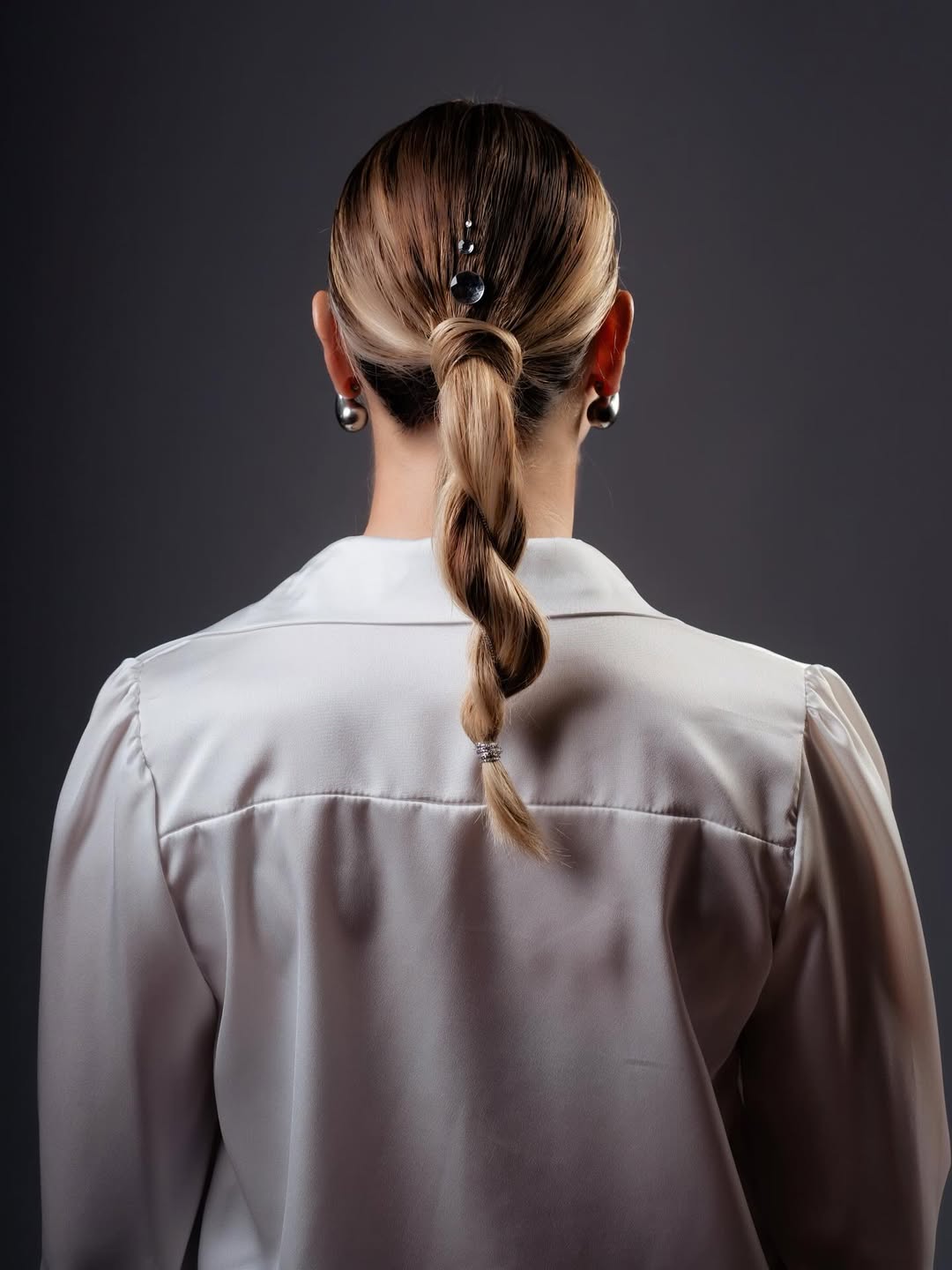 Sleek Low Swirl Ponytail With Pearl Accents
