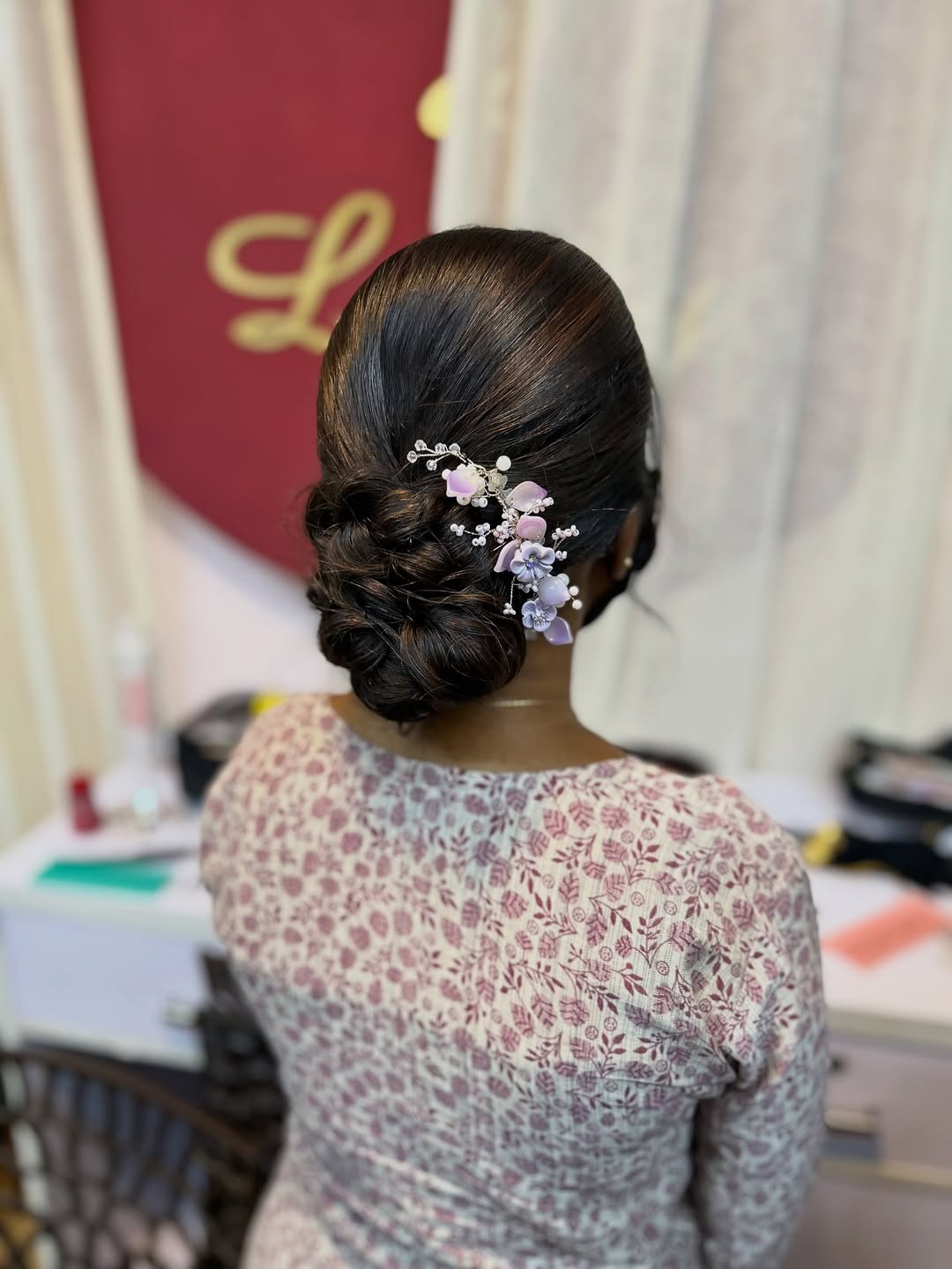 Sleek Low Textured Bun with Floral Accessory