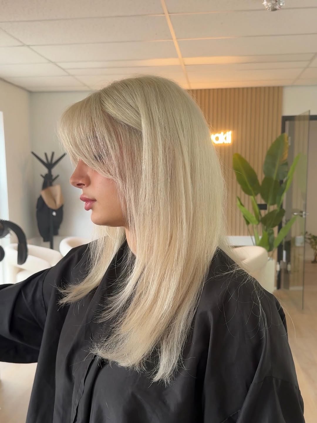 Sleek Platinum Blonde Hair With Soft Curtain Bangs