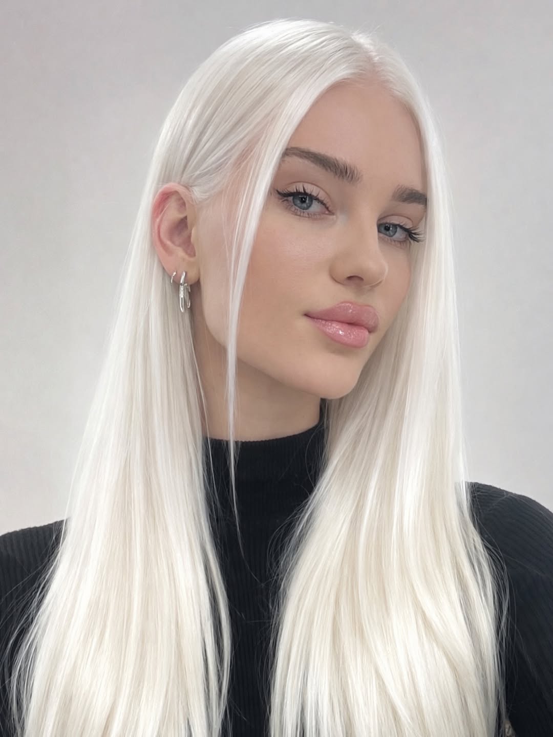 Sleek Platinum Blonde Mid-Back Length Hair